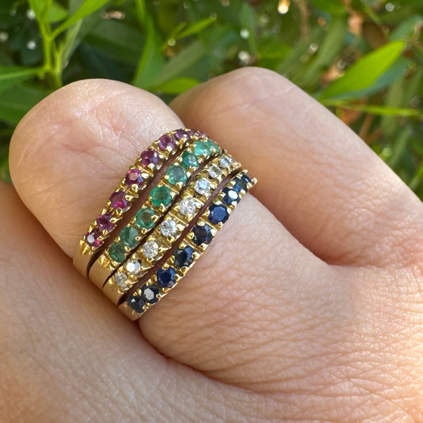18K yellow gold ring set with vibrant rows of Sapphires, Emeralds, Rubies, and Diamonds