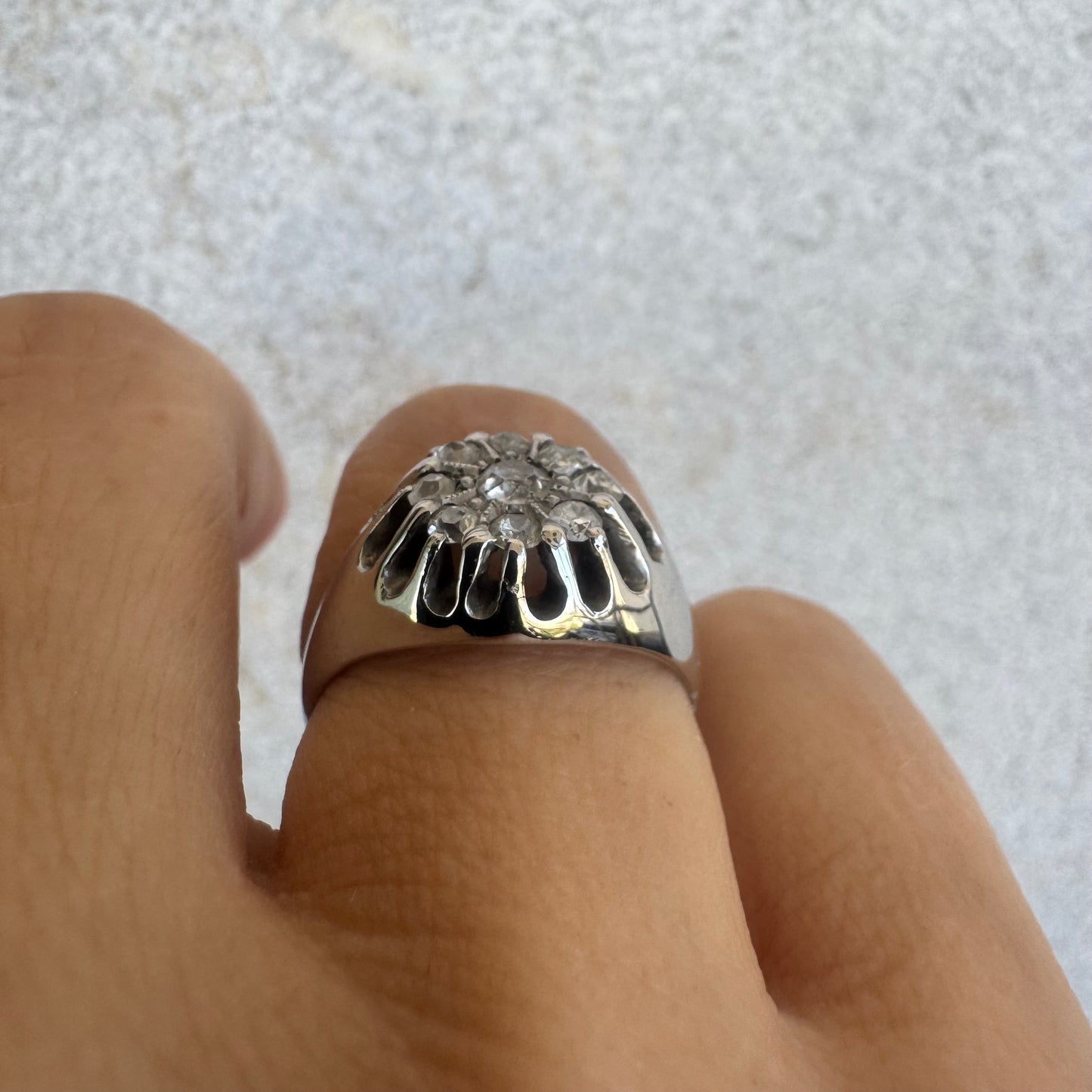 14K gold ring set with a cluster of old cut diamonds arranged in a floral design