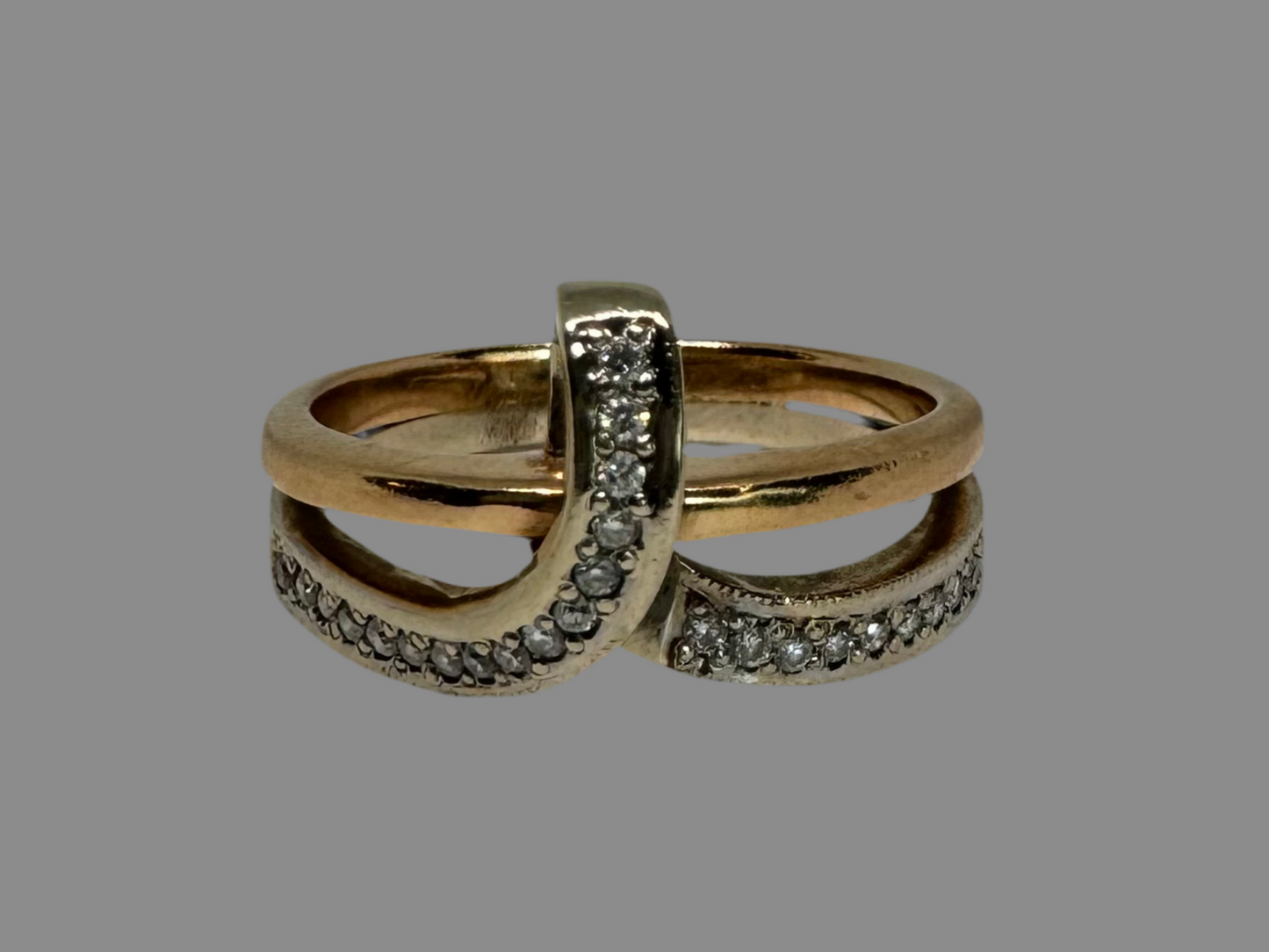 18K two-tone gold (rose & white) crossover ring featuring a row of sparkling Diamonds along each band, creating an elegant and modern design.