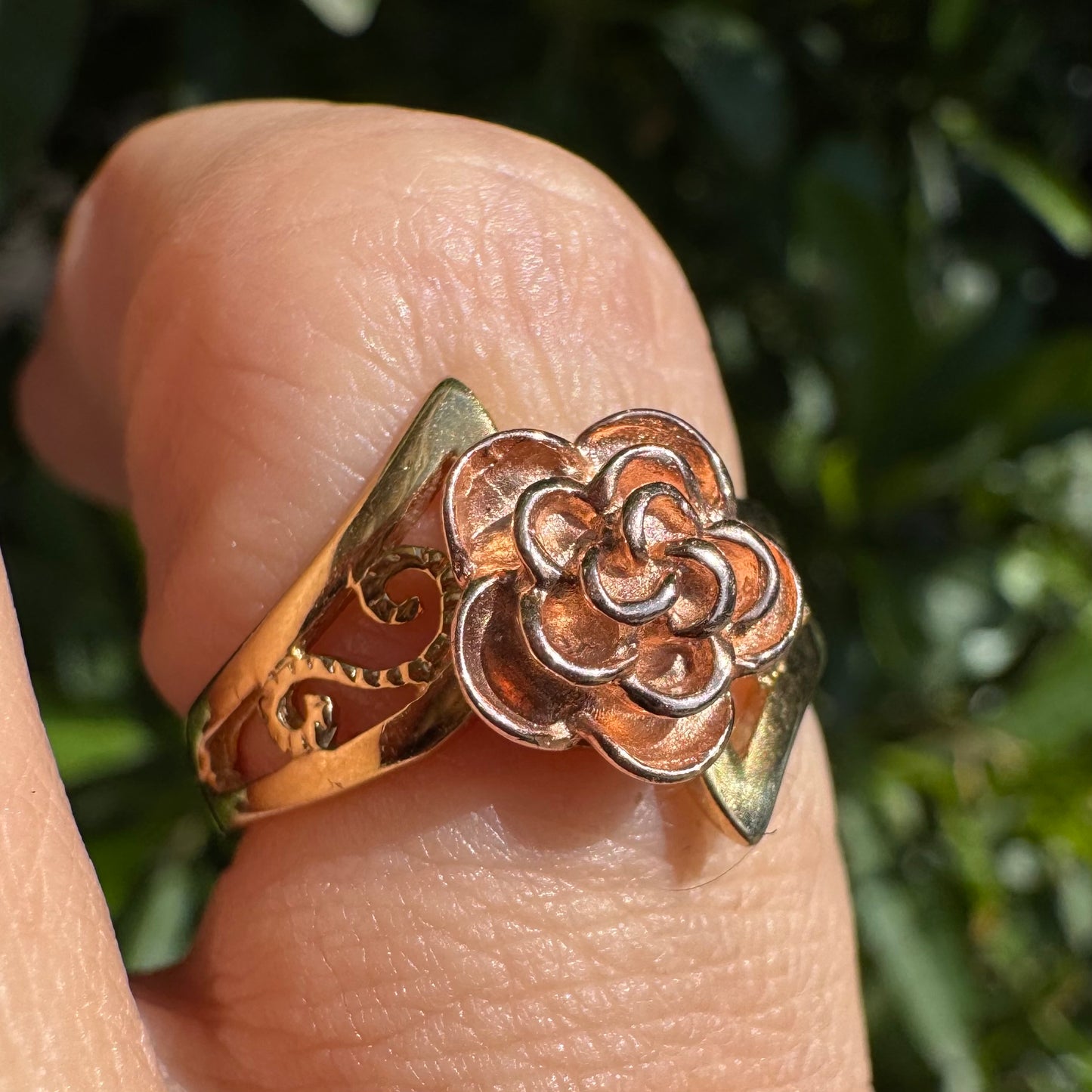 10K two tone gold with a sculpted rose at its center