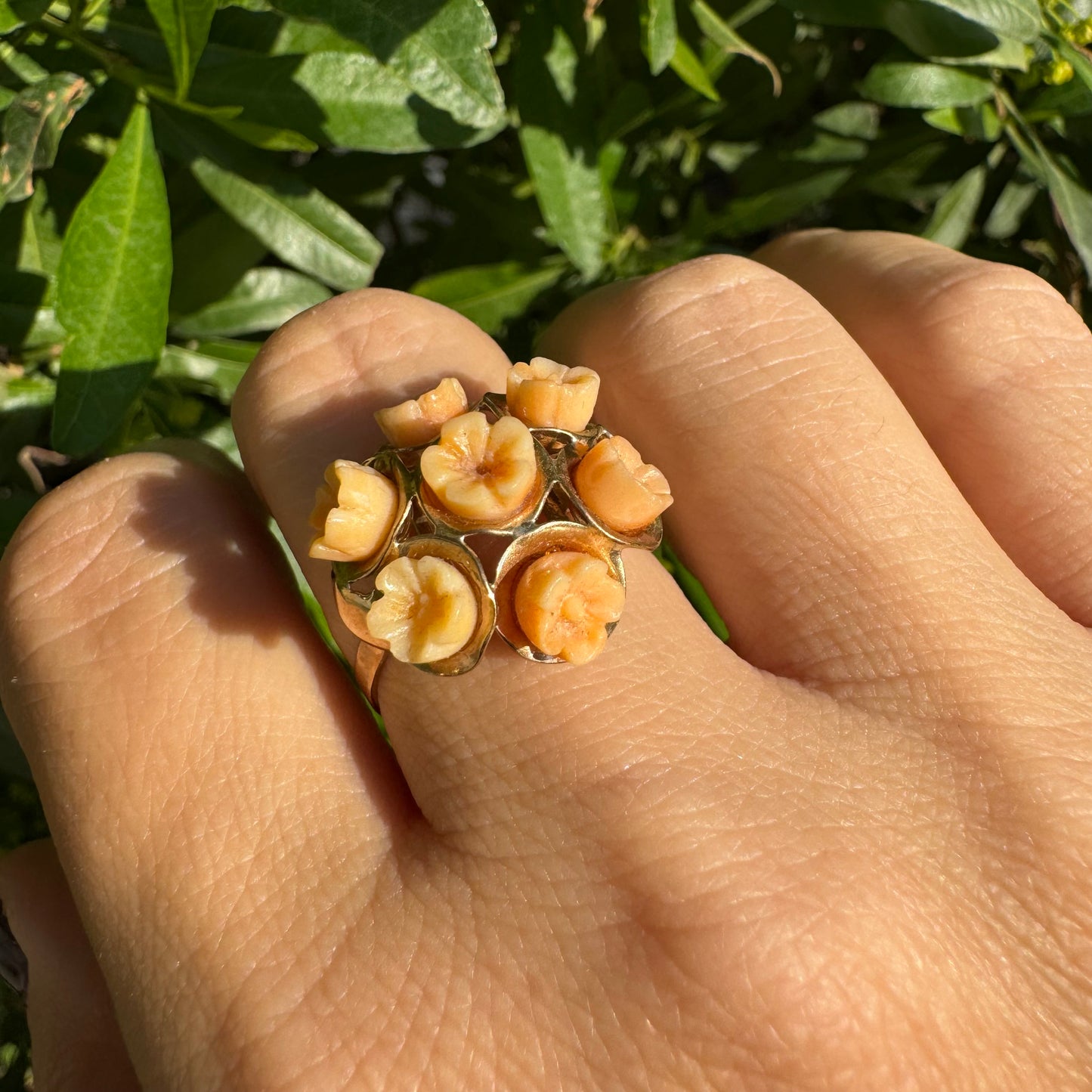9K gold ring featuring a cluster design with carved Coral flowers in warm orange tones