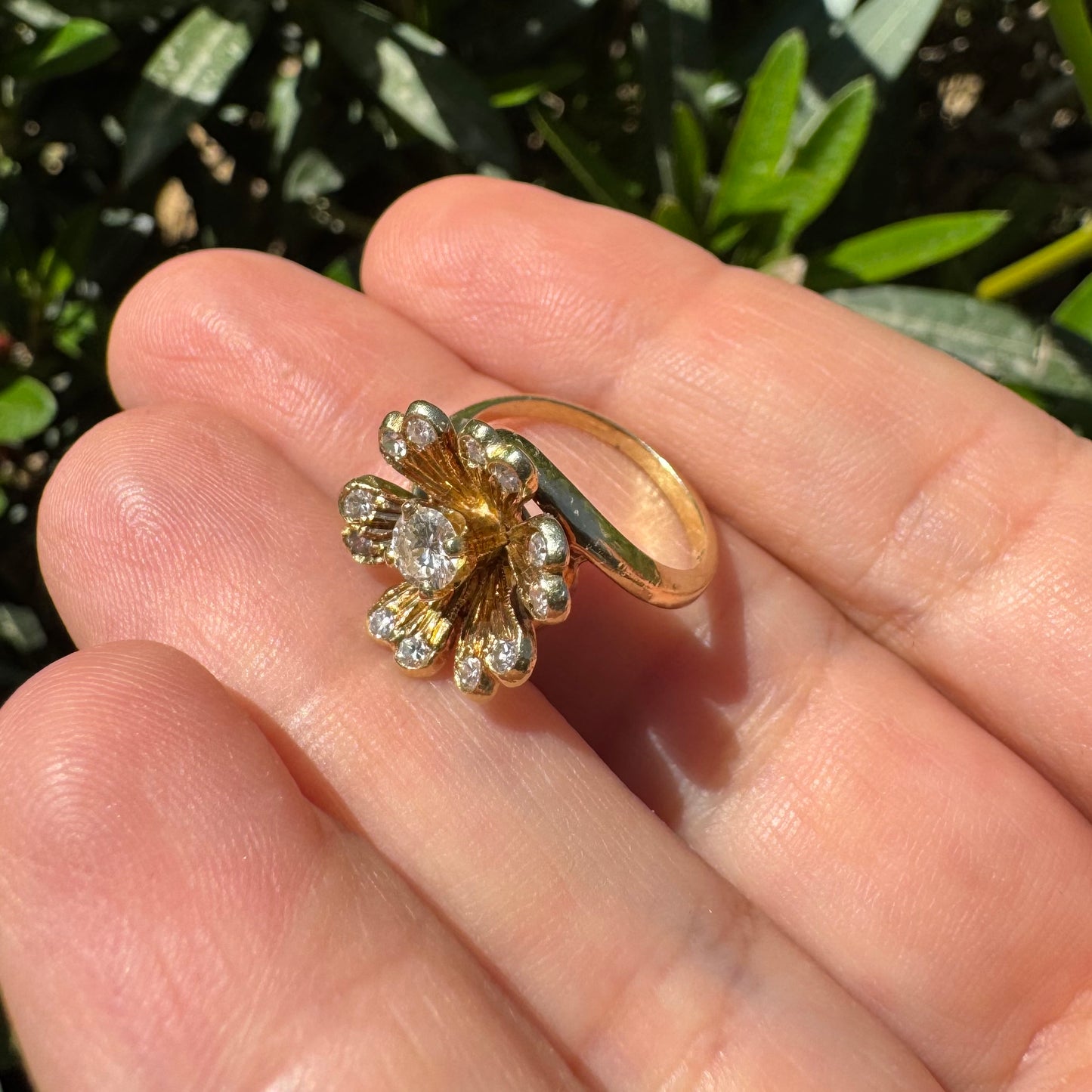 14K gold ring in a floral design, set with sparkling Diamonds at the center and around the petals.