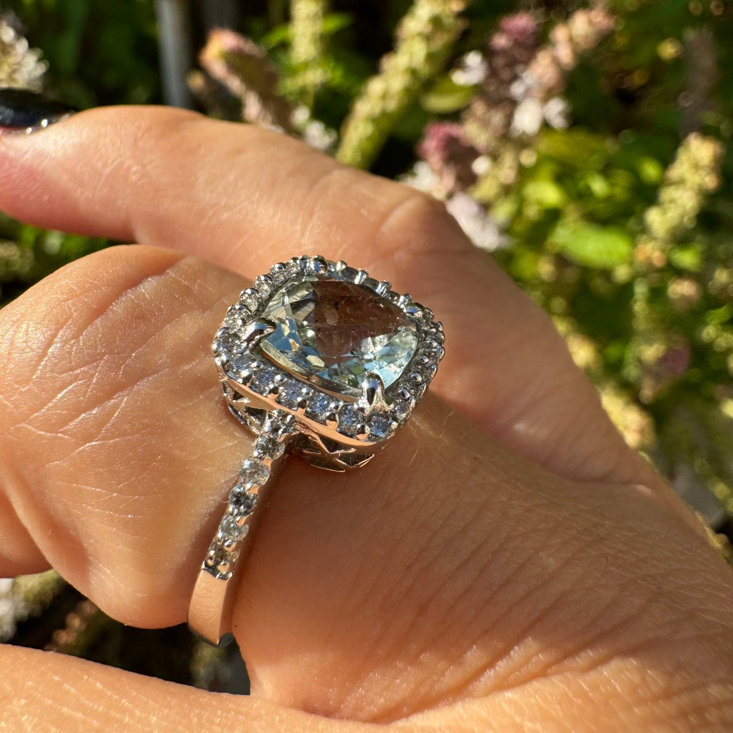 14K white gold ring featuring a cushion-cut light blue Aquamarine set in a sparkling double halo of round-cut Diamonds.