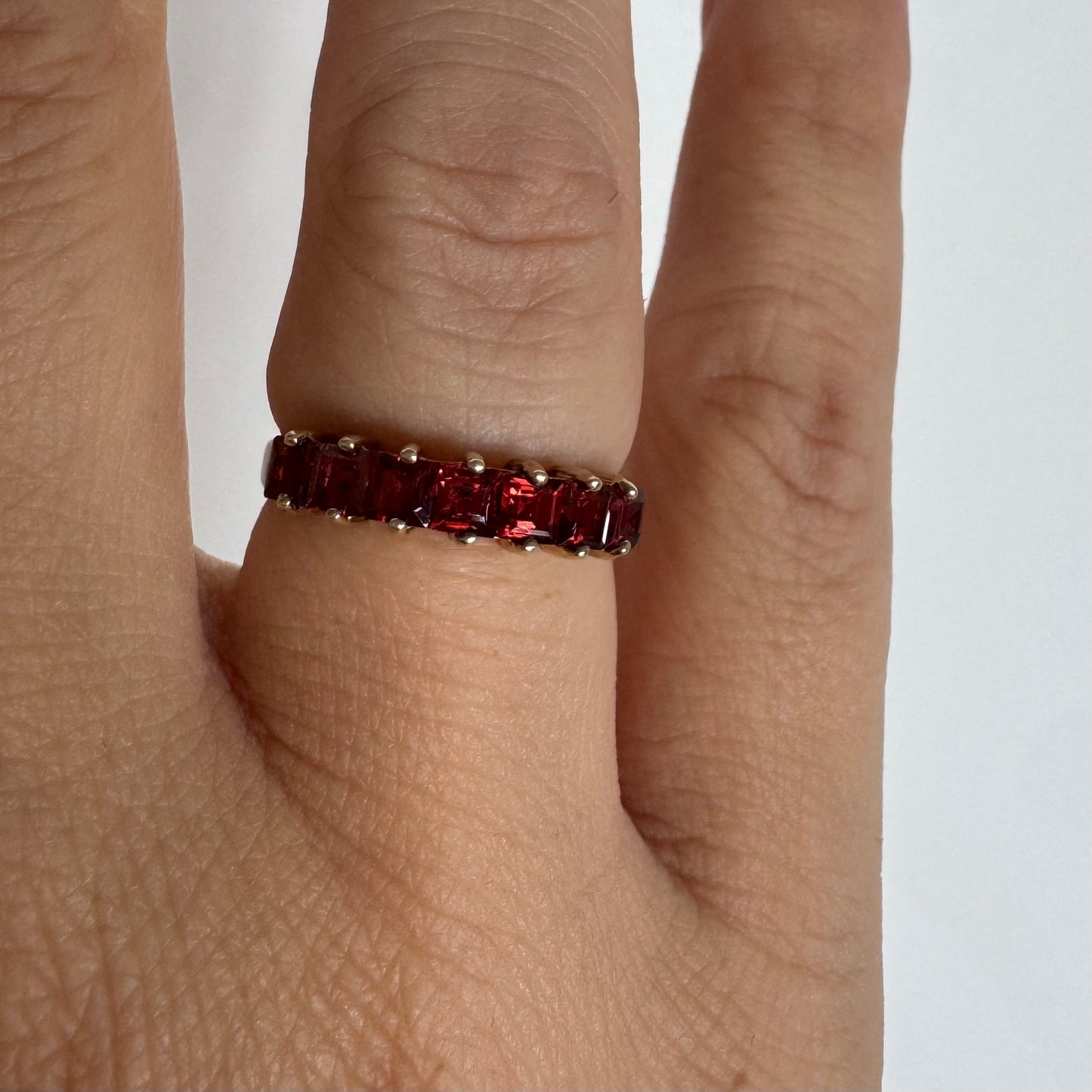 9K gold ring set with deep red garnets