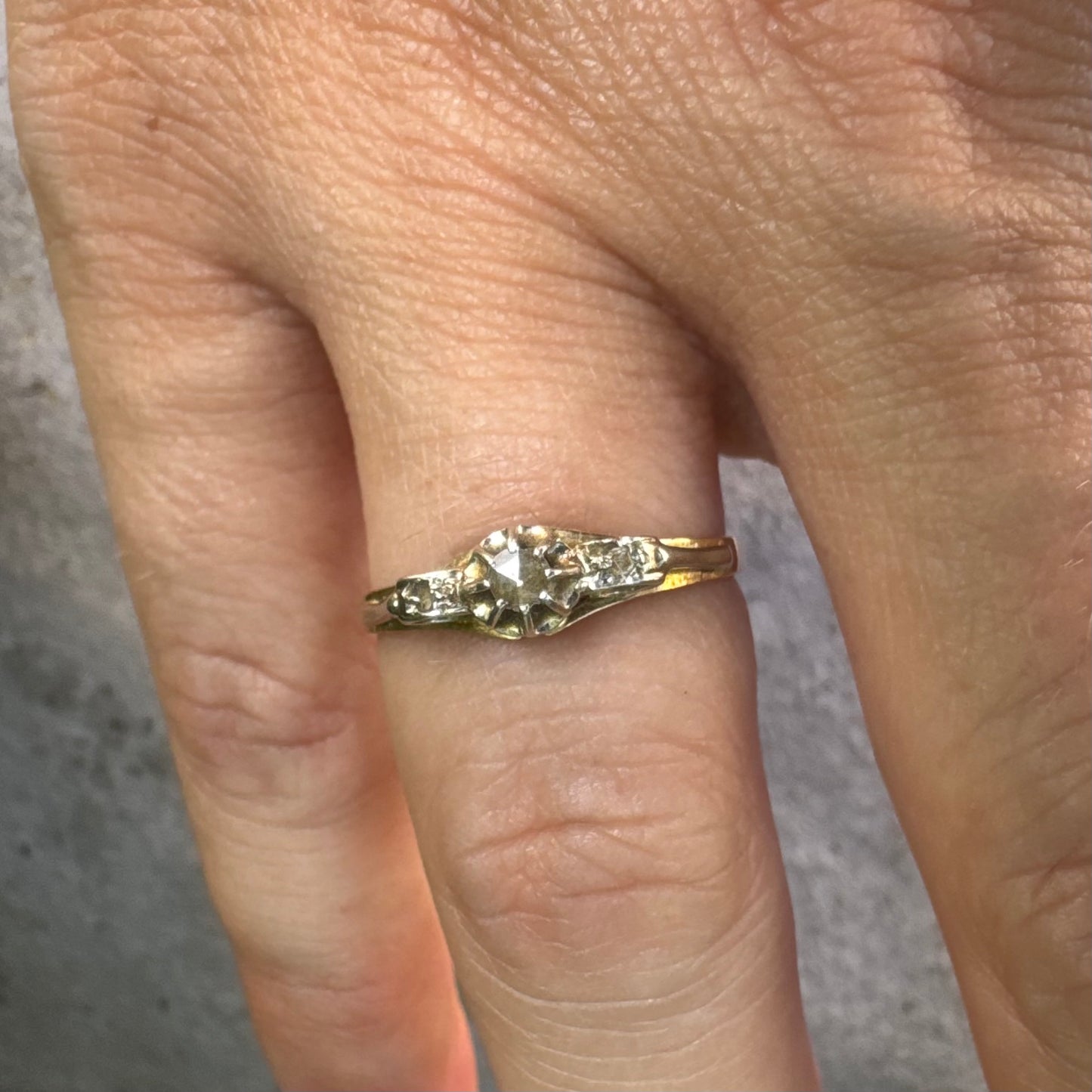 18K gold ring set with an old-cut center Diamond & side Diamonds