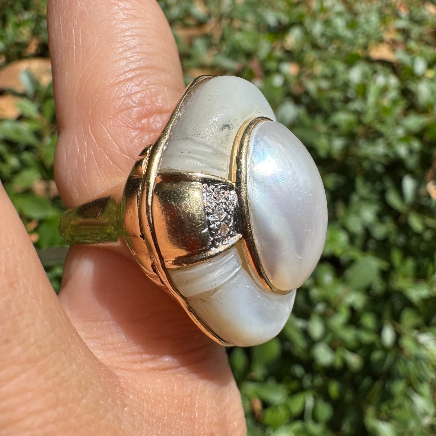 14K gold ring set with a natural mother-of-pearl centerpiece framed by delicate diamond accents