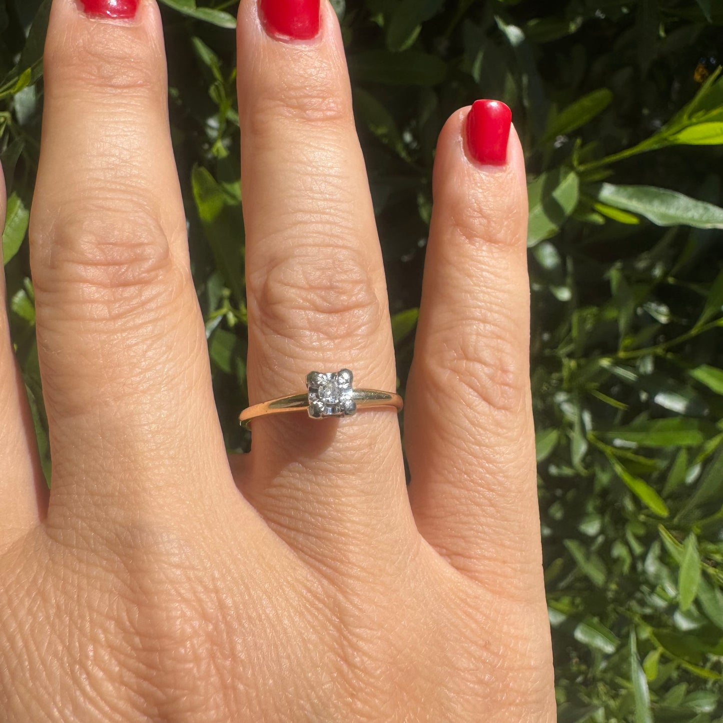 14K gold solitaire ring set with a small round Diamond