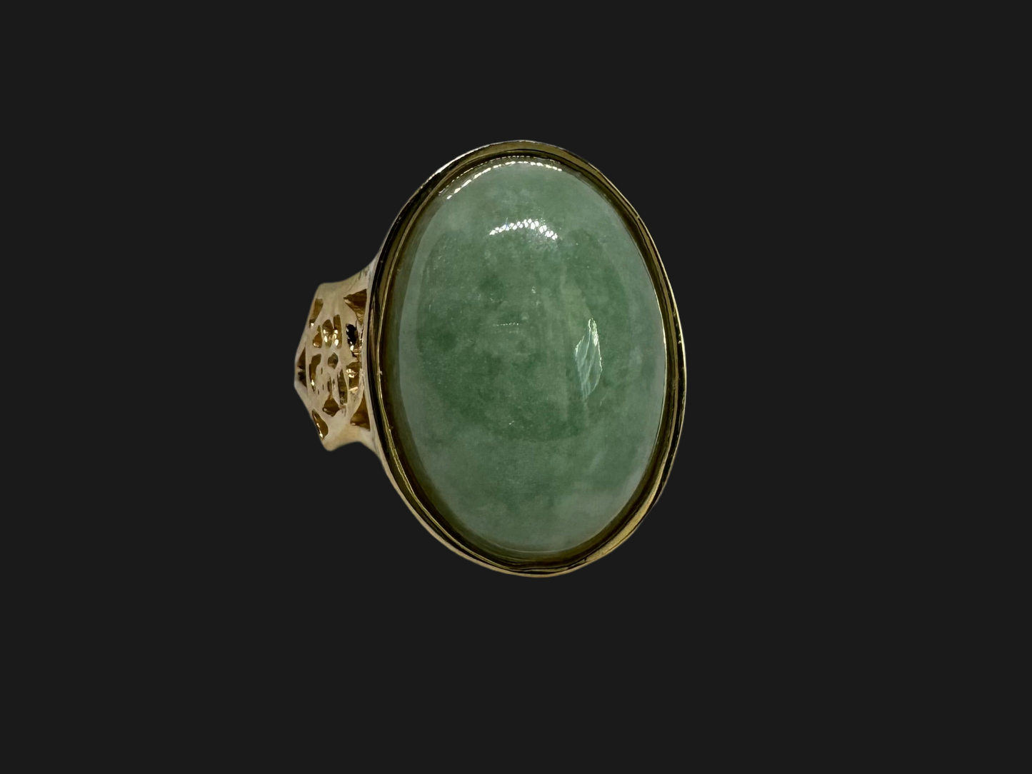 14K gold ring featuring a large oval light green Jade with a smooth polished finish, set in a classic bezel setting.