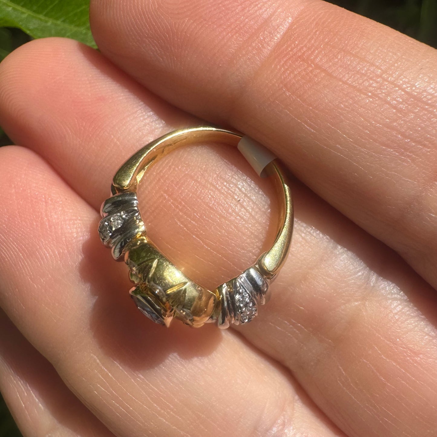 18K two-tone gold ring set with an oval Tanzanite & round brilliant diamonds