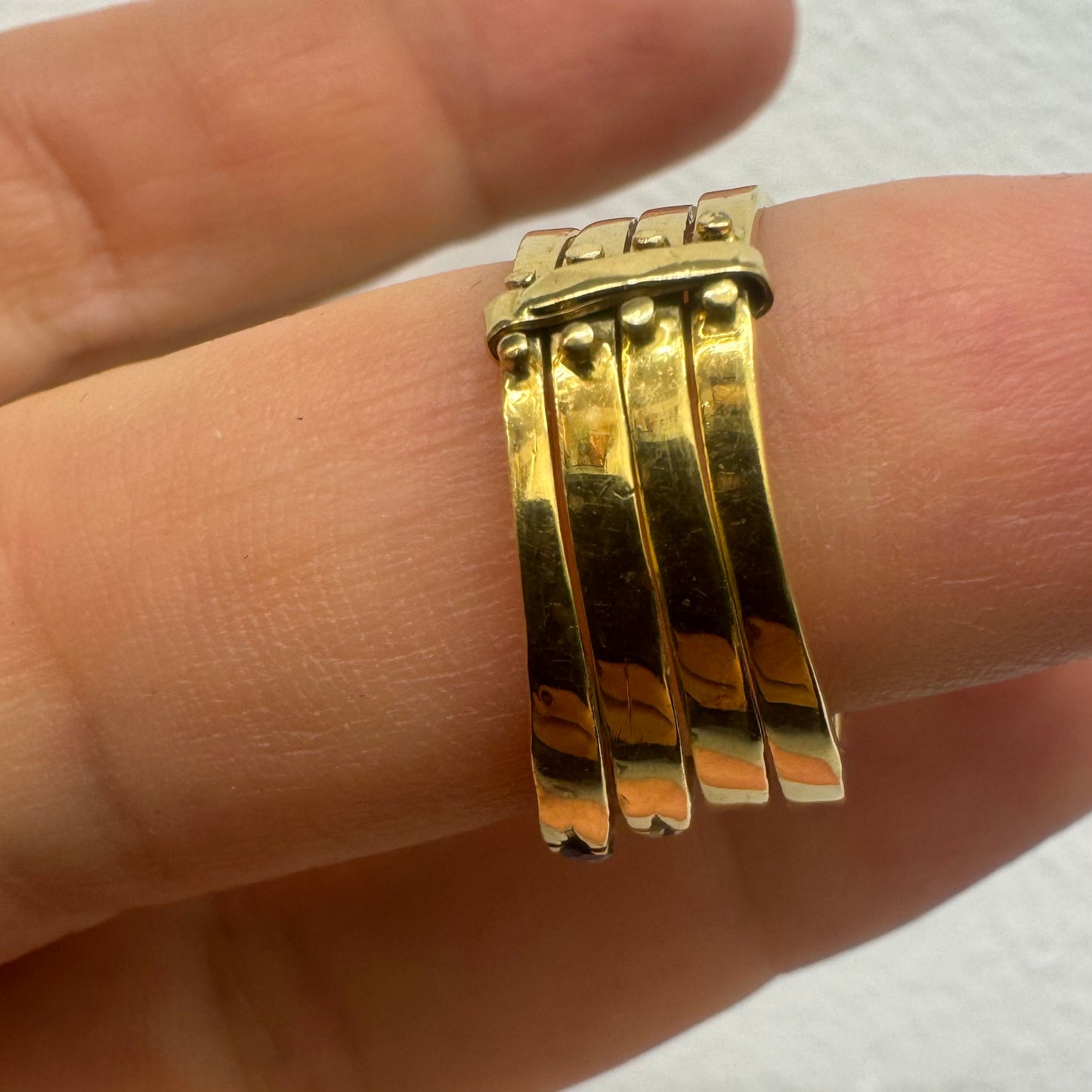 18K yellow gold ring set with vibrant rows of Sapphires, Emeralds, Rubies, and Diamonds