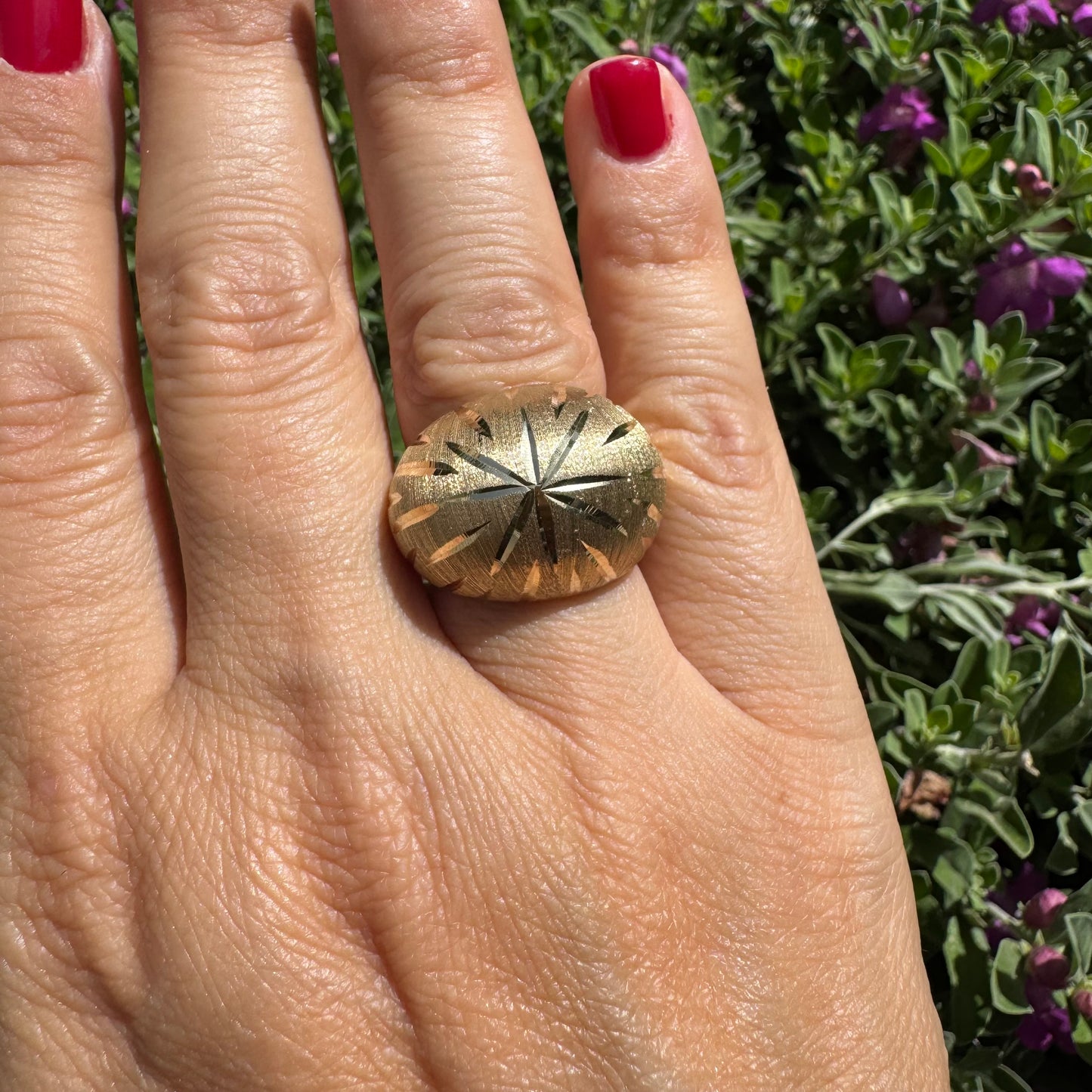 14K gold dome ring crafted in textured gold, featuring intricate engraved starburst detailing