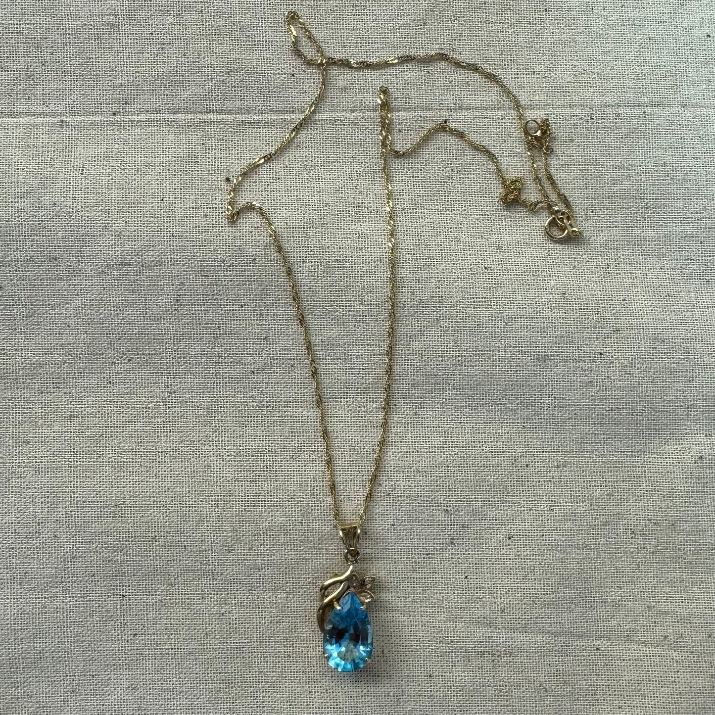 14K gold necklace set with Blue Topaz pendant in a teardrop cut