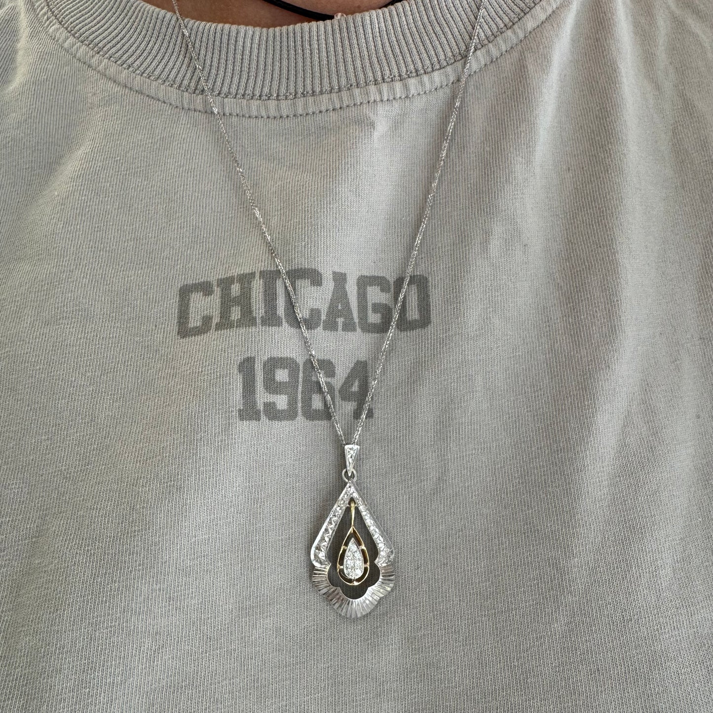 14K white and yellow gold pendant in a unique geometric design set with Diamonds