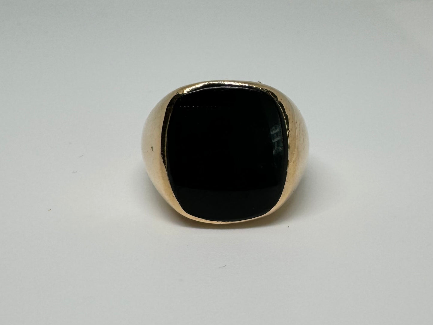 14K bold gold ring set with a smooth, square-shaped black Onyx that creates a sleek and striking look.