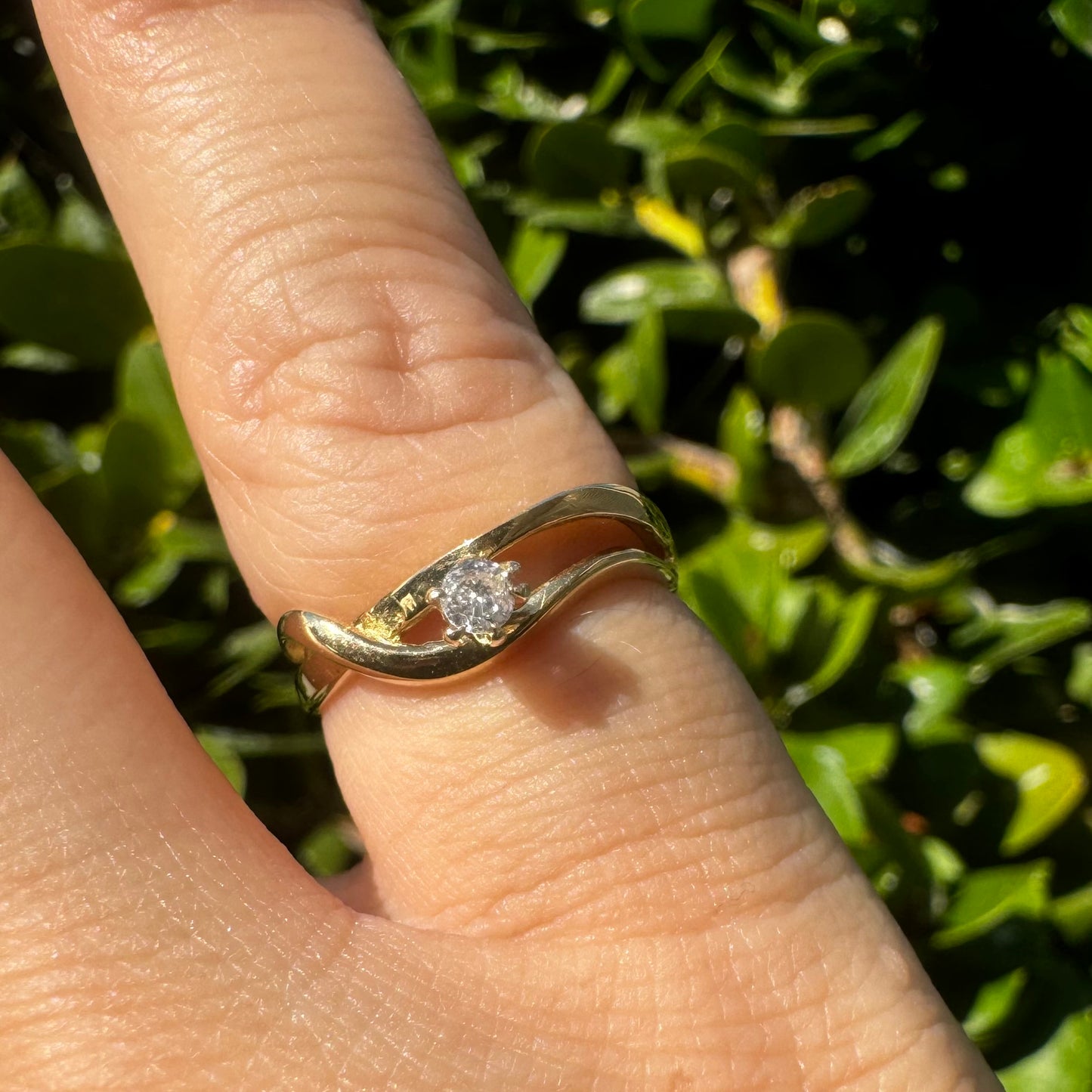 14K gold ring set with a single brilliant-cut diamond