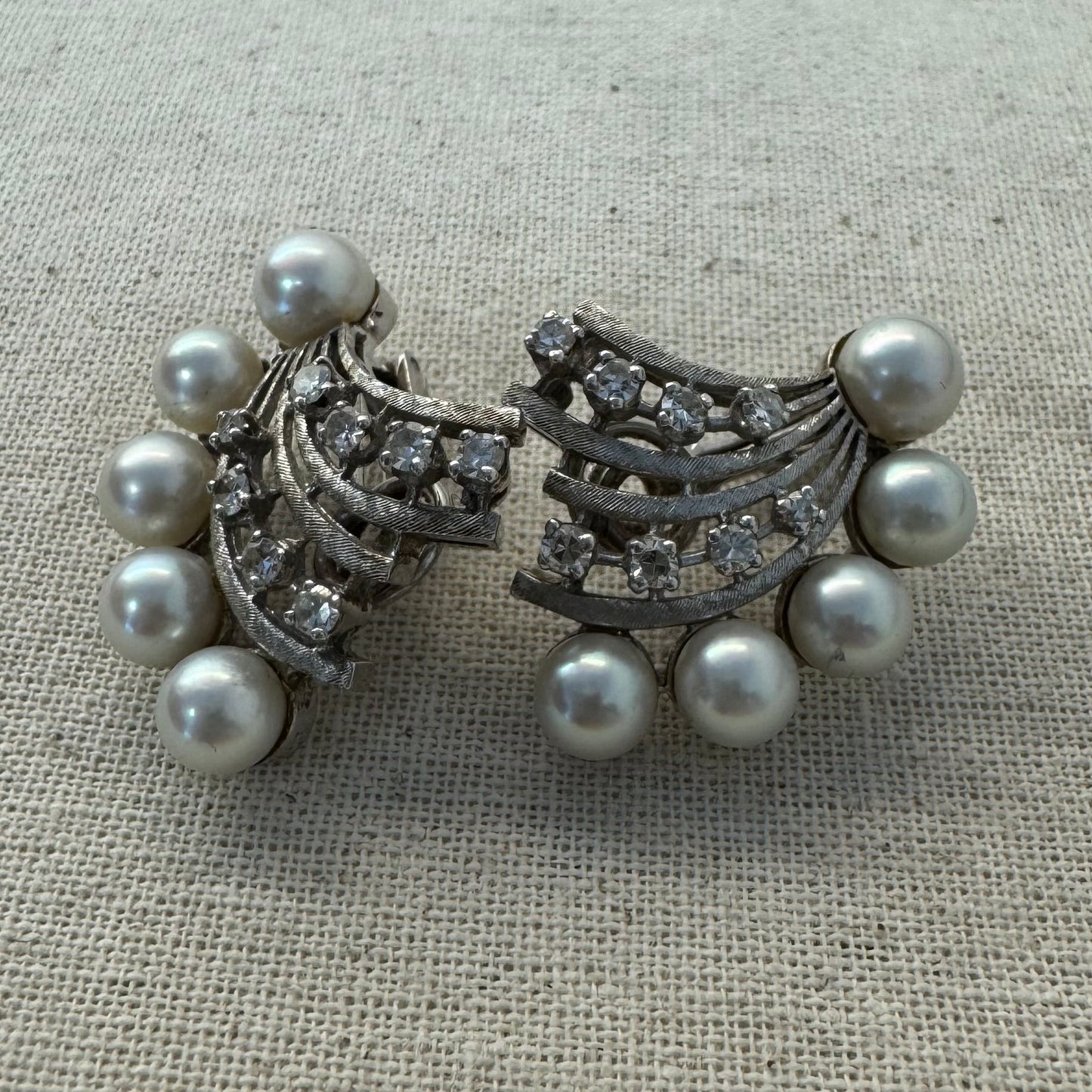 14K gold clip-on earrings inspired by 1950s Hollywood style, set with a row of luminous round pearls & Diamonds