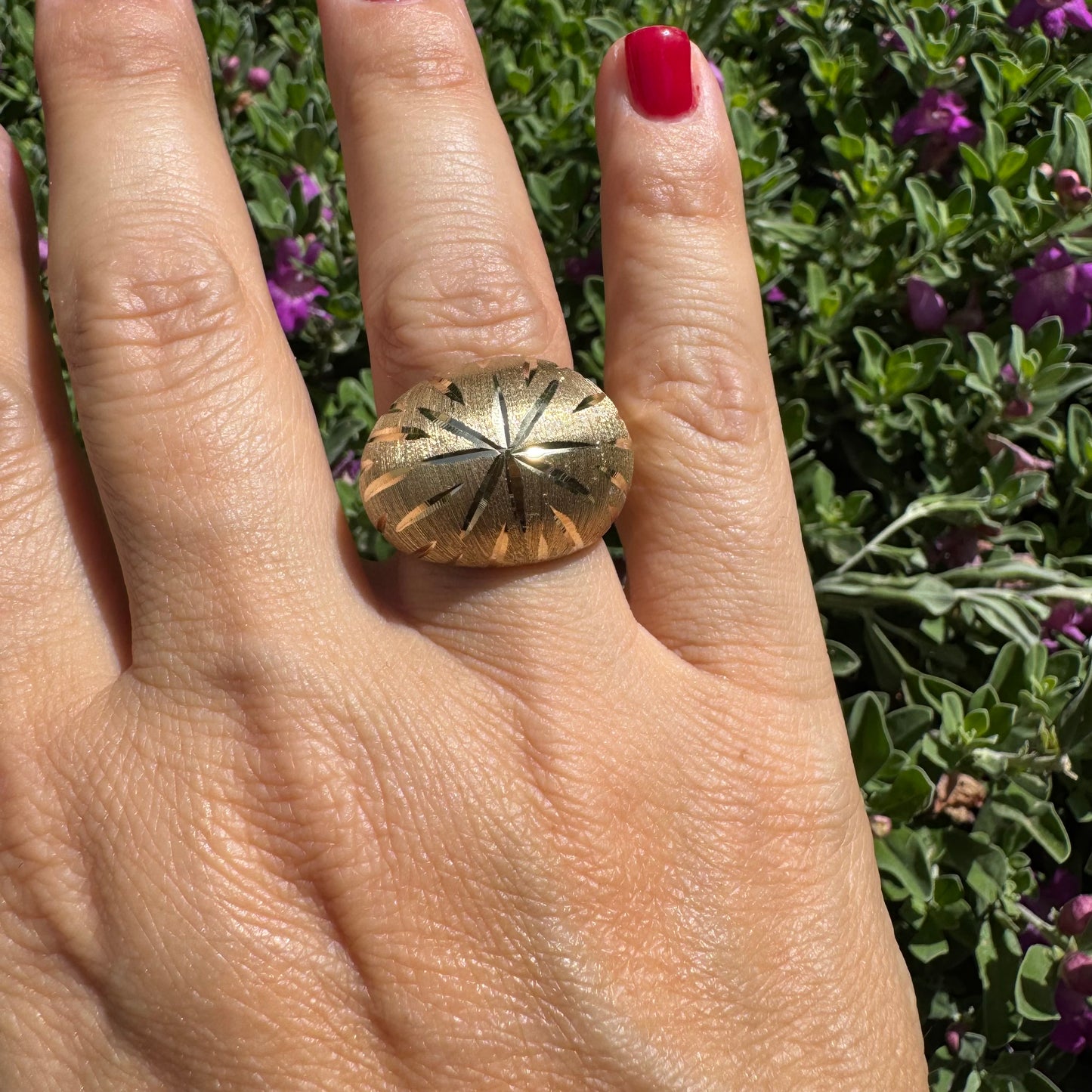 14K gold dome ring crafted in textured gold, featuring intricate engraved starburst detailing