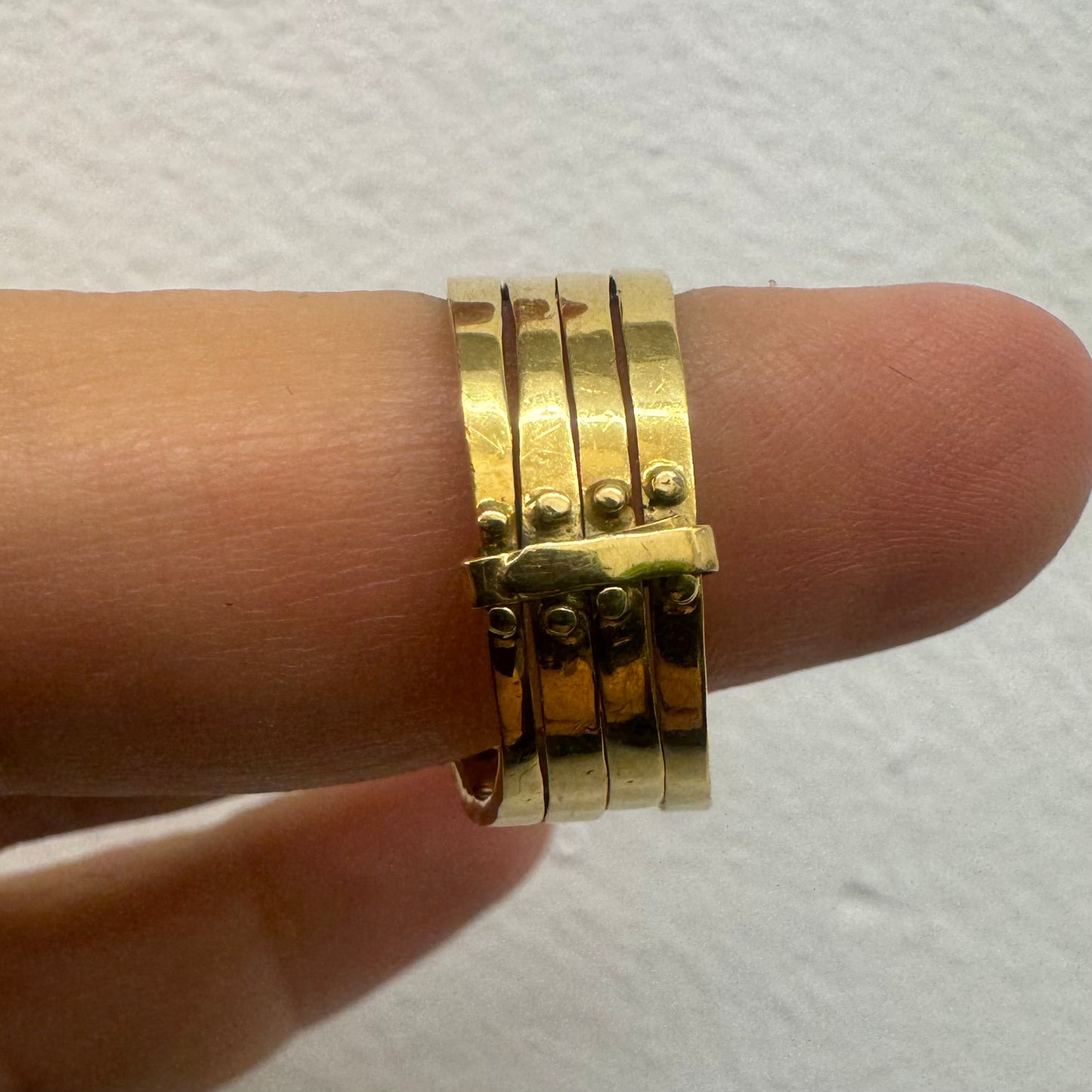 18K yellow gold ring set with vibrant rows of Sapphires, Emeralds, Rubies, and Diamonds