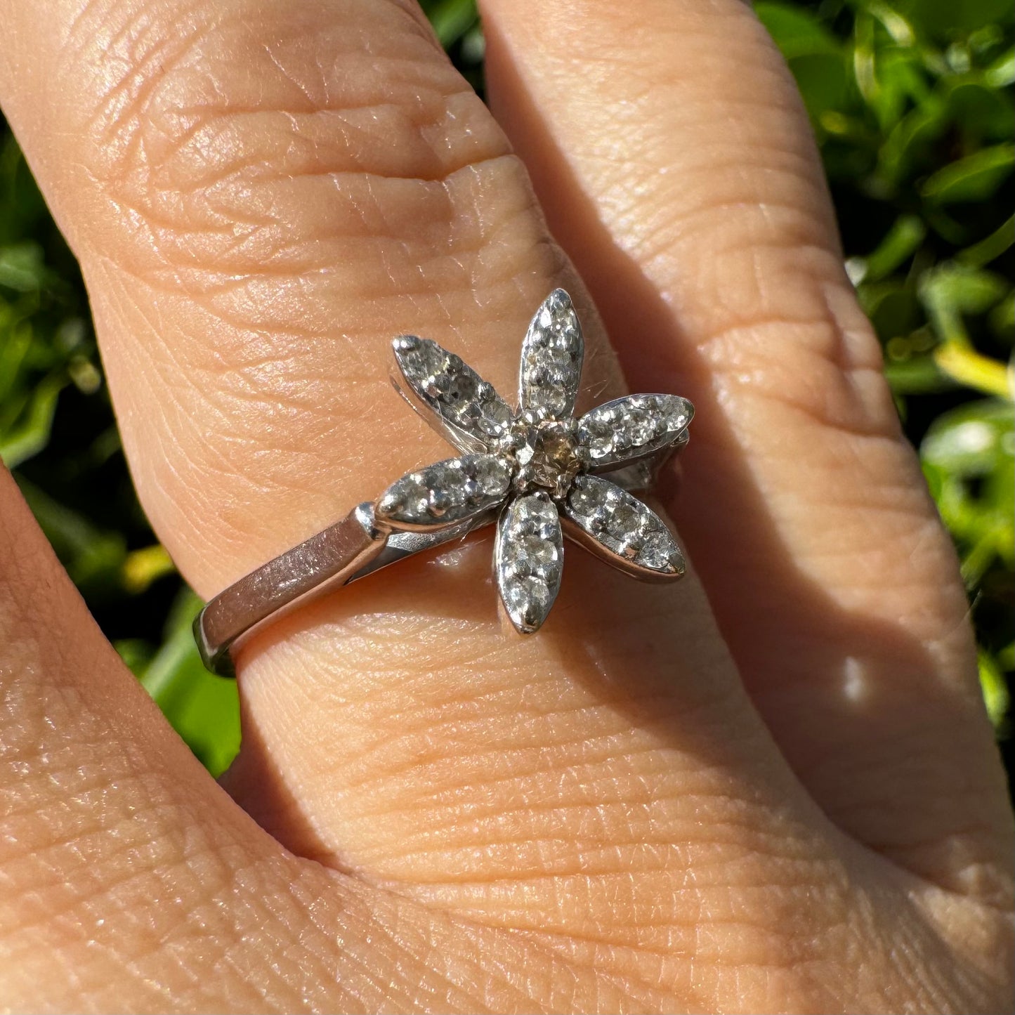 14K gold ring set with a floral design with six petal-shaped segments, each pavé-set with shimmering Diamonds