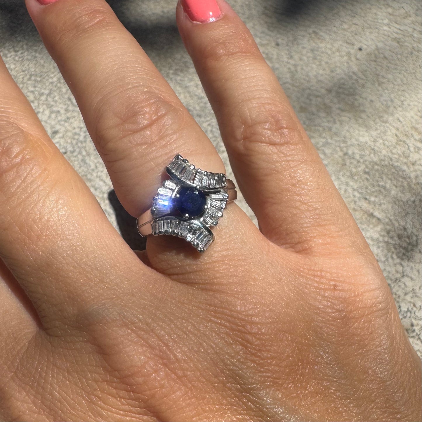 14K gold ring set with a marquise-cut Sapphire at its center, framed by an intricate halo of sparkling Diamonds