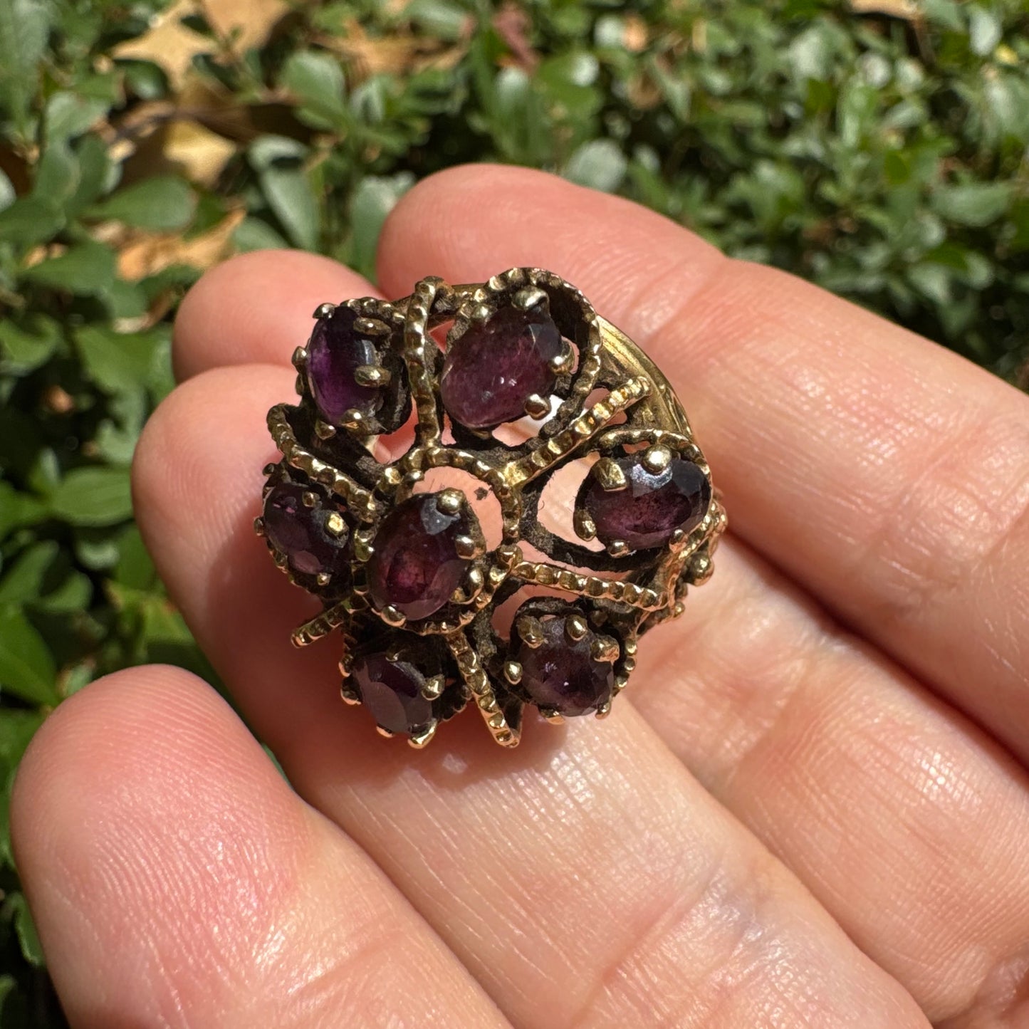 14K gold cocktail ring set with a stunning cluster of deep purple Garnet stones in marquise cuts.