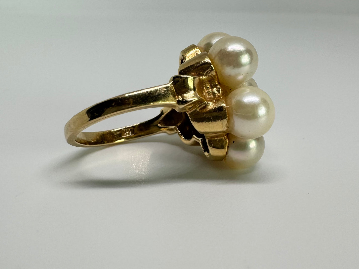 14K gold ring set with seven round Pearls in a bold floral cluster