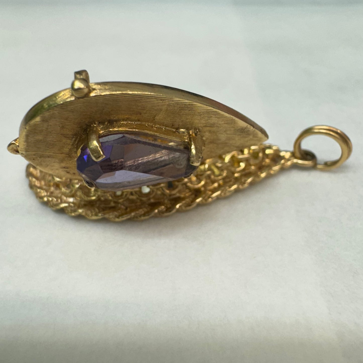 14K gold locket pendant set with an Amethyst gemstone