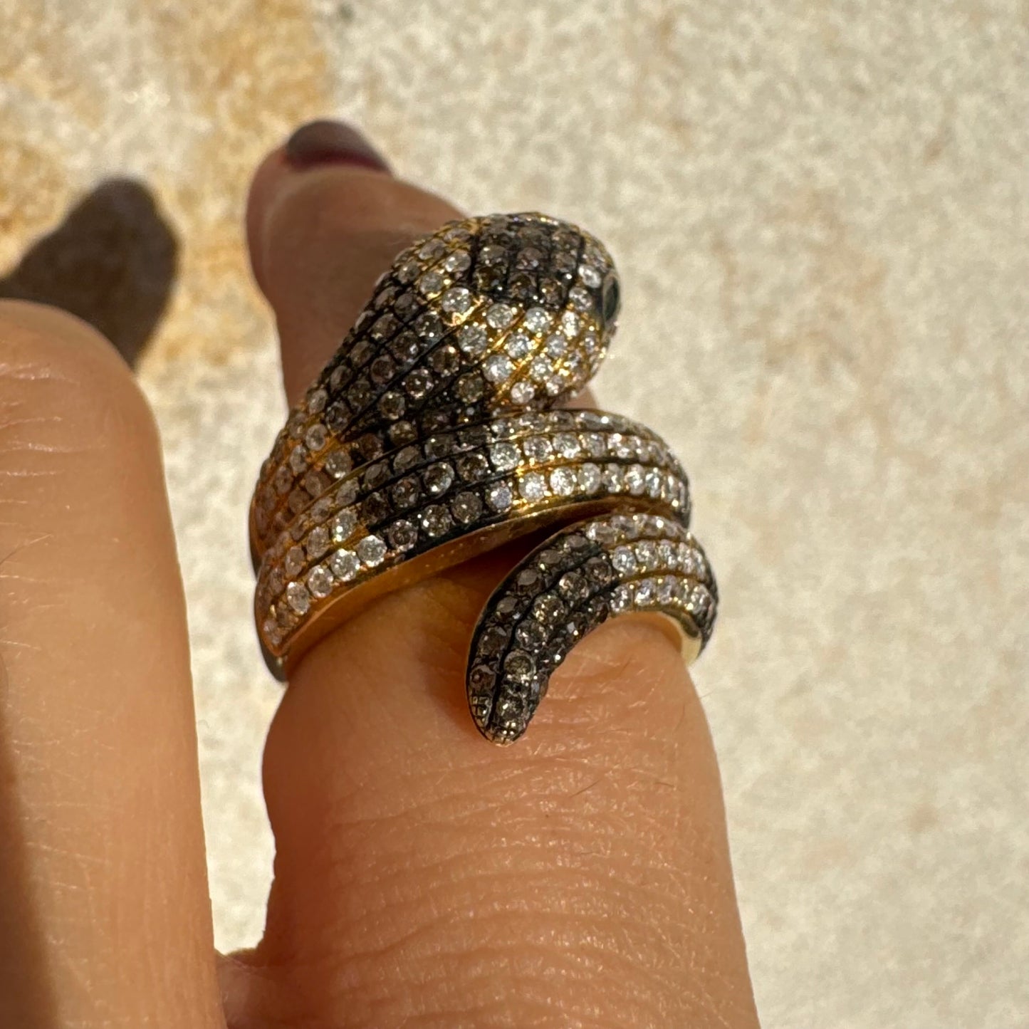 14K gold snake ring fully set with white and black Diamonds, creating a striking contrast and luxurious sparkle.