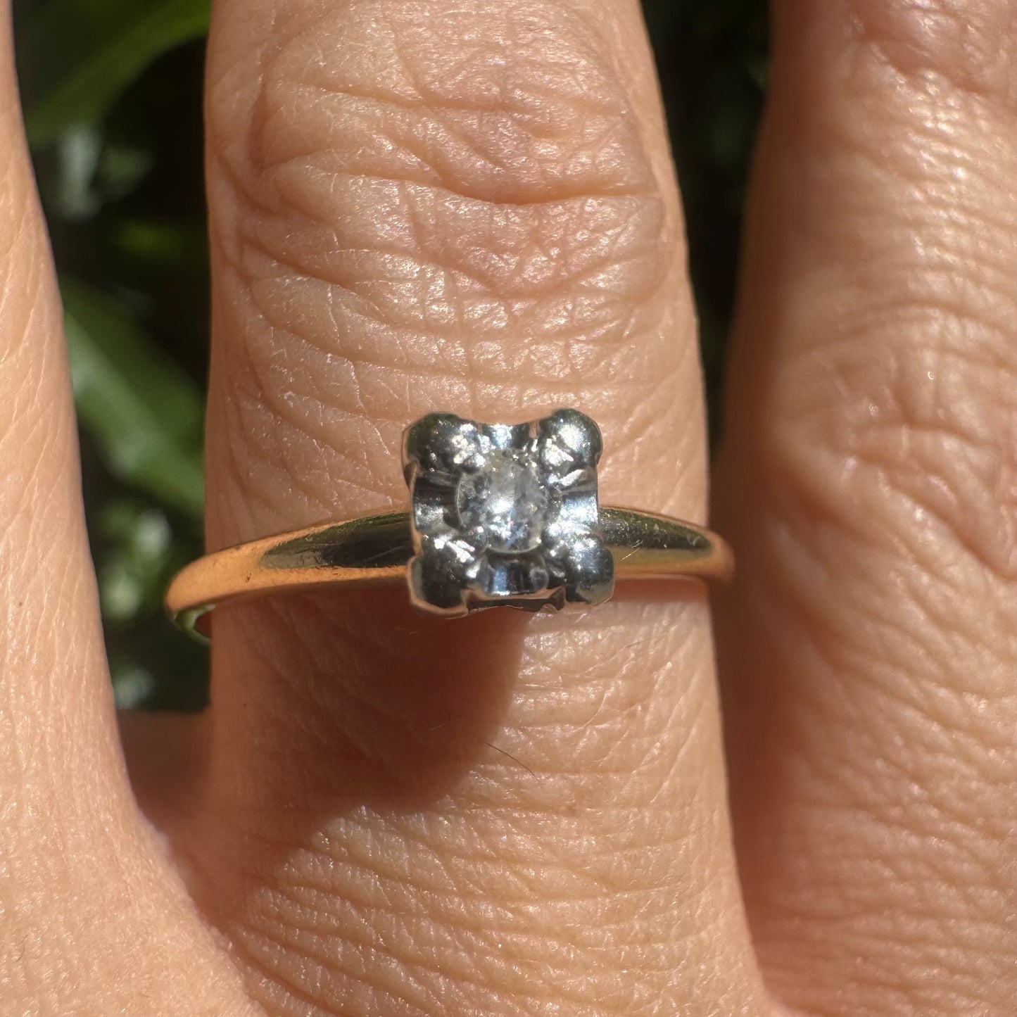 14K gold solitaire ring set with a small round Diamond