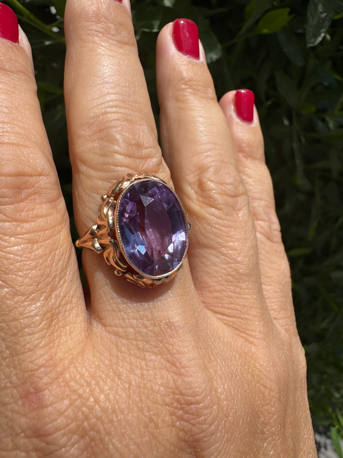 14K gold ring set with a large oval-cut Amethyst in a regal claw setting.