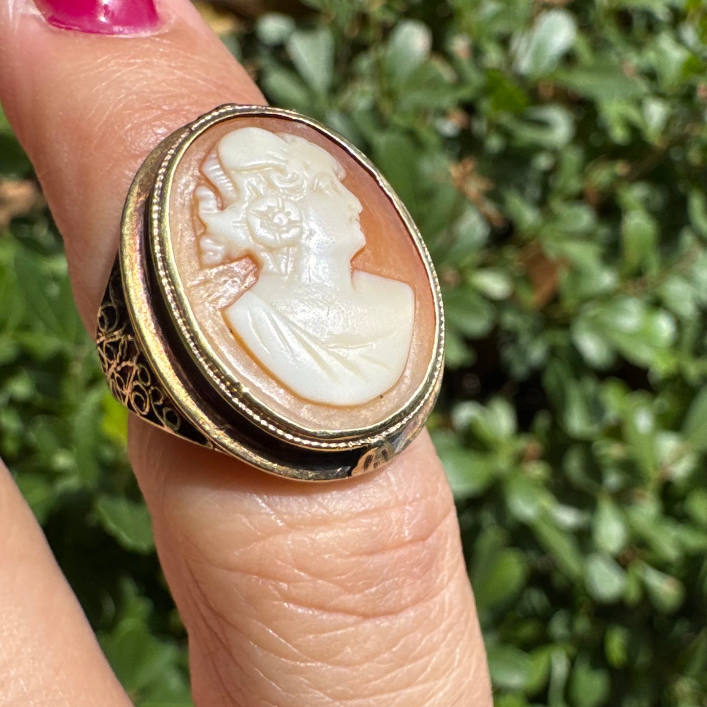 14K gold cameo ring featuring a finely carved portrait of a woman in profile, set in an oval bezel with intricate gold detailing