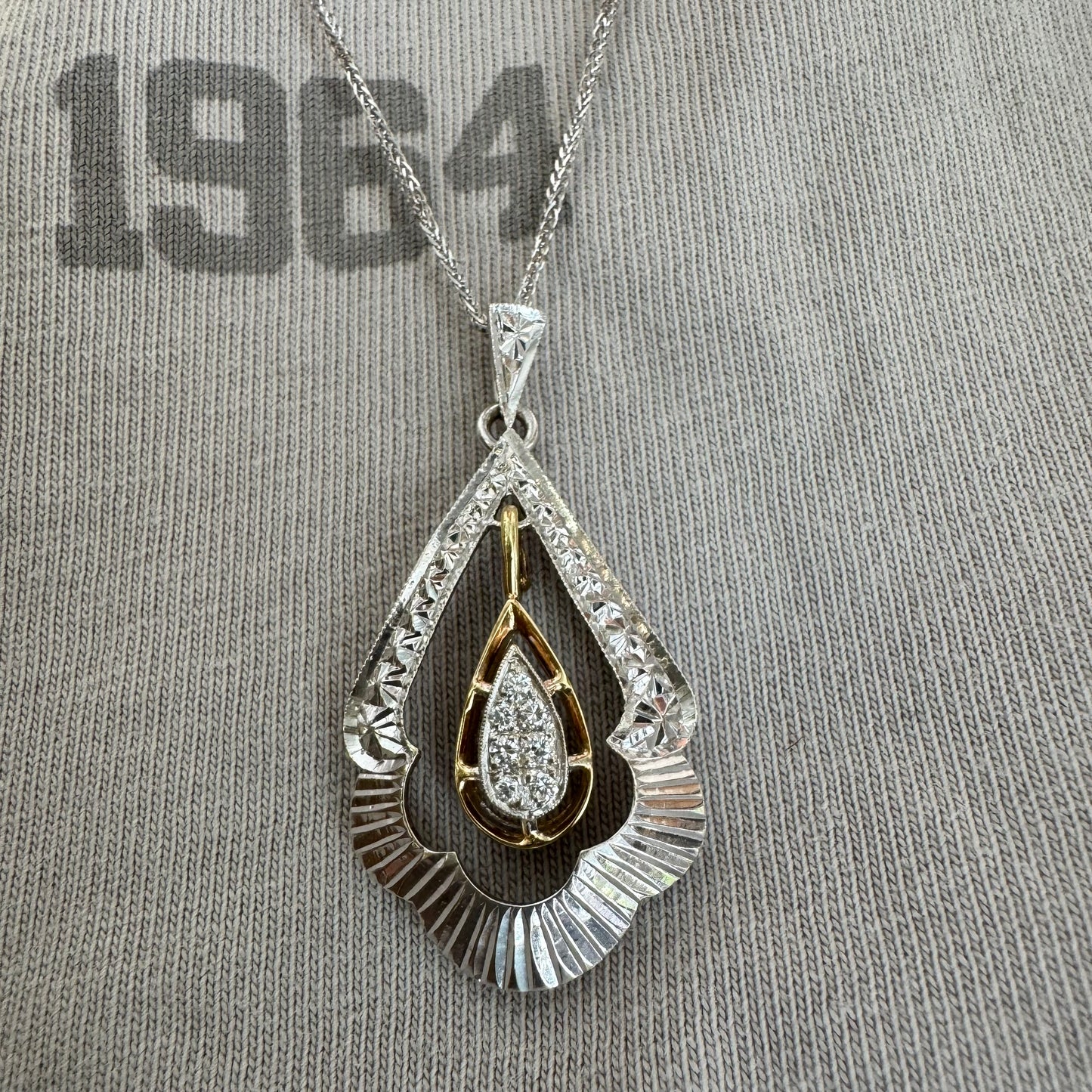 14K white and yellow gold pendant in a unique geometric design set with Diamonds