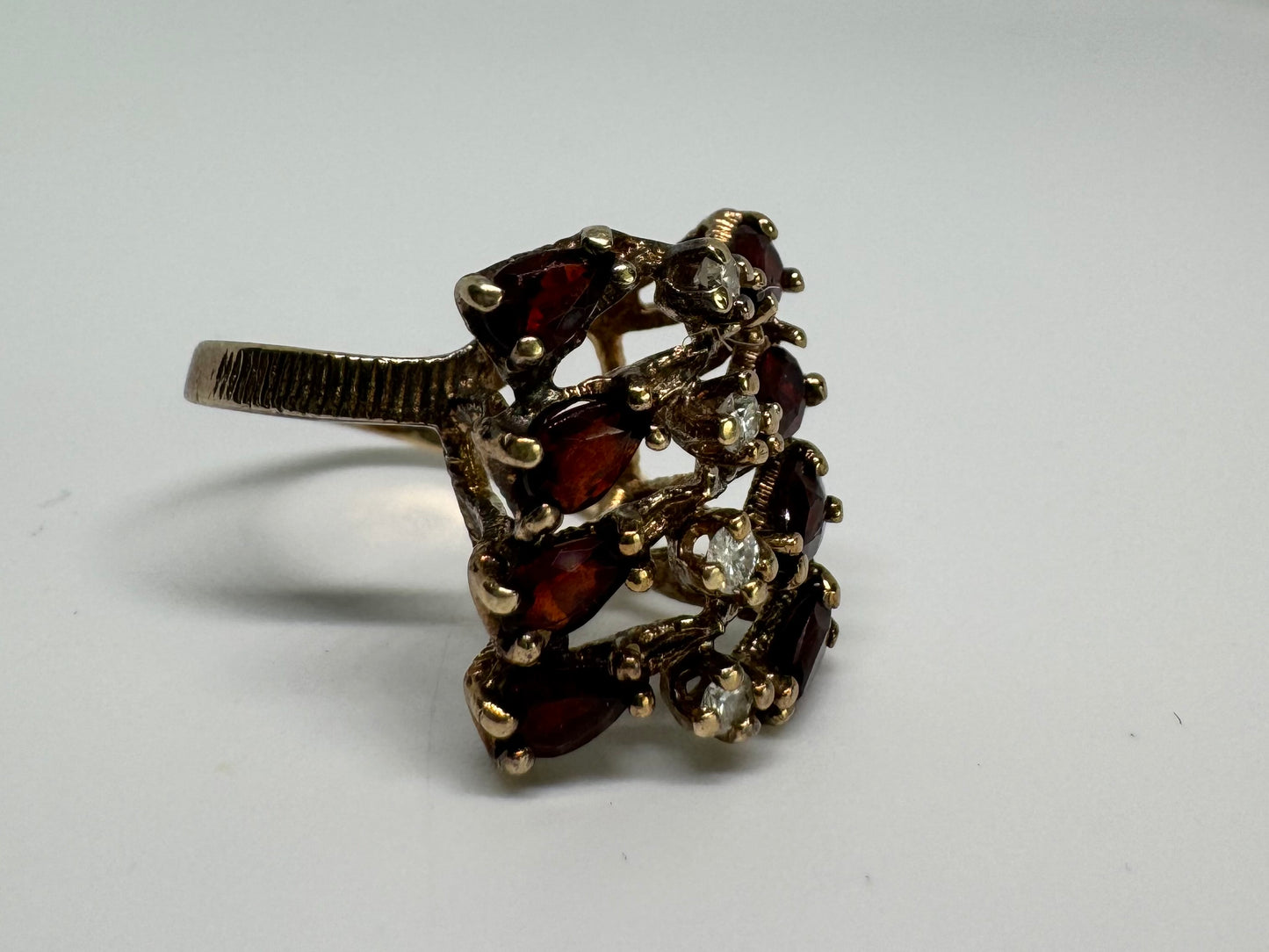 14K gold ring set with deep red teardrop Garnets and sparkling Diamonds in an openwork geometric design