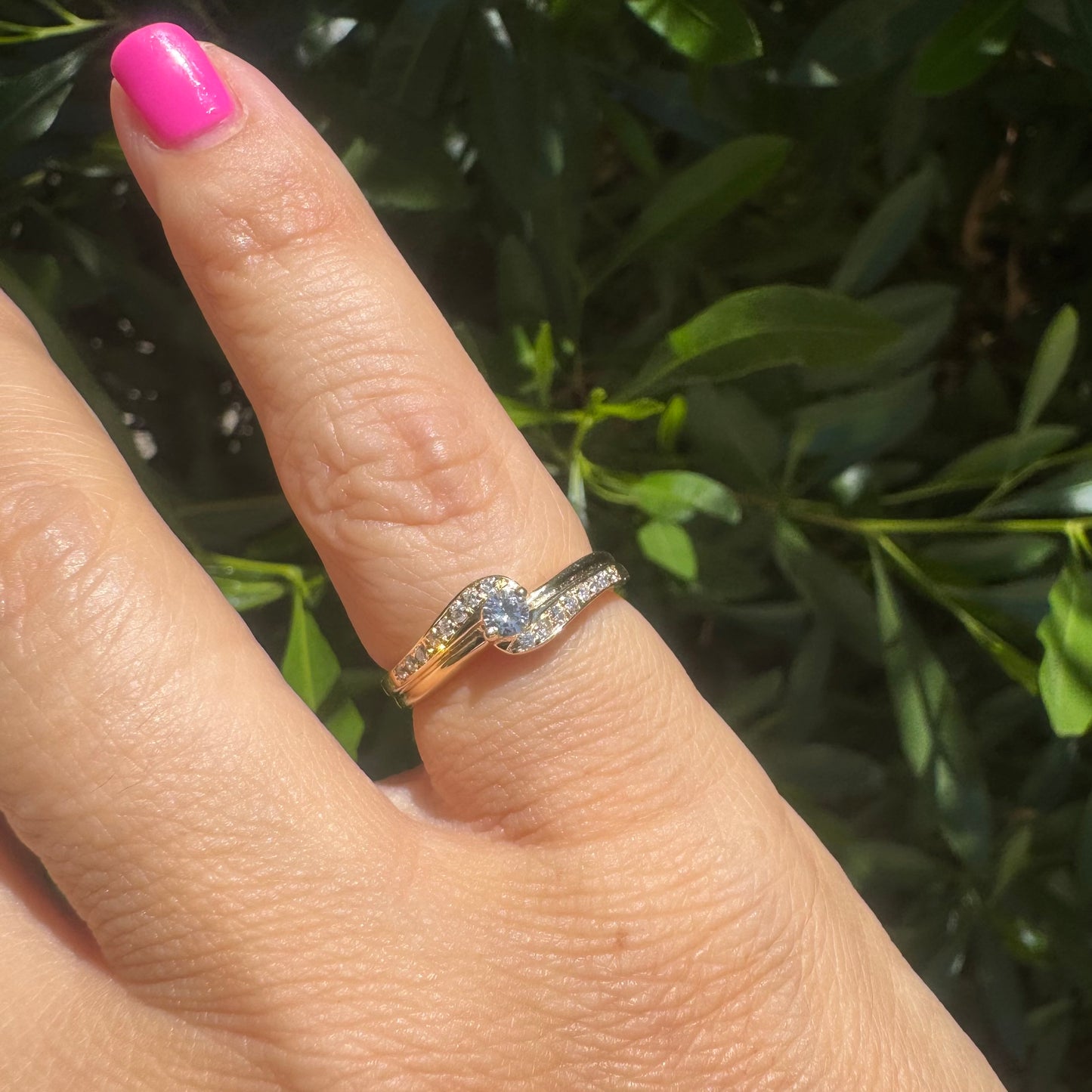 14K gold ring featuring a classic solitaire Diamond at its center, embraced by a pavé-set band