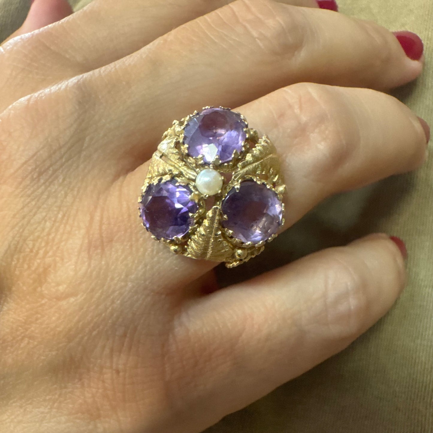 14K gold ring set with four glowing Amethyst stones encircling a delicate central Pearl.