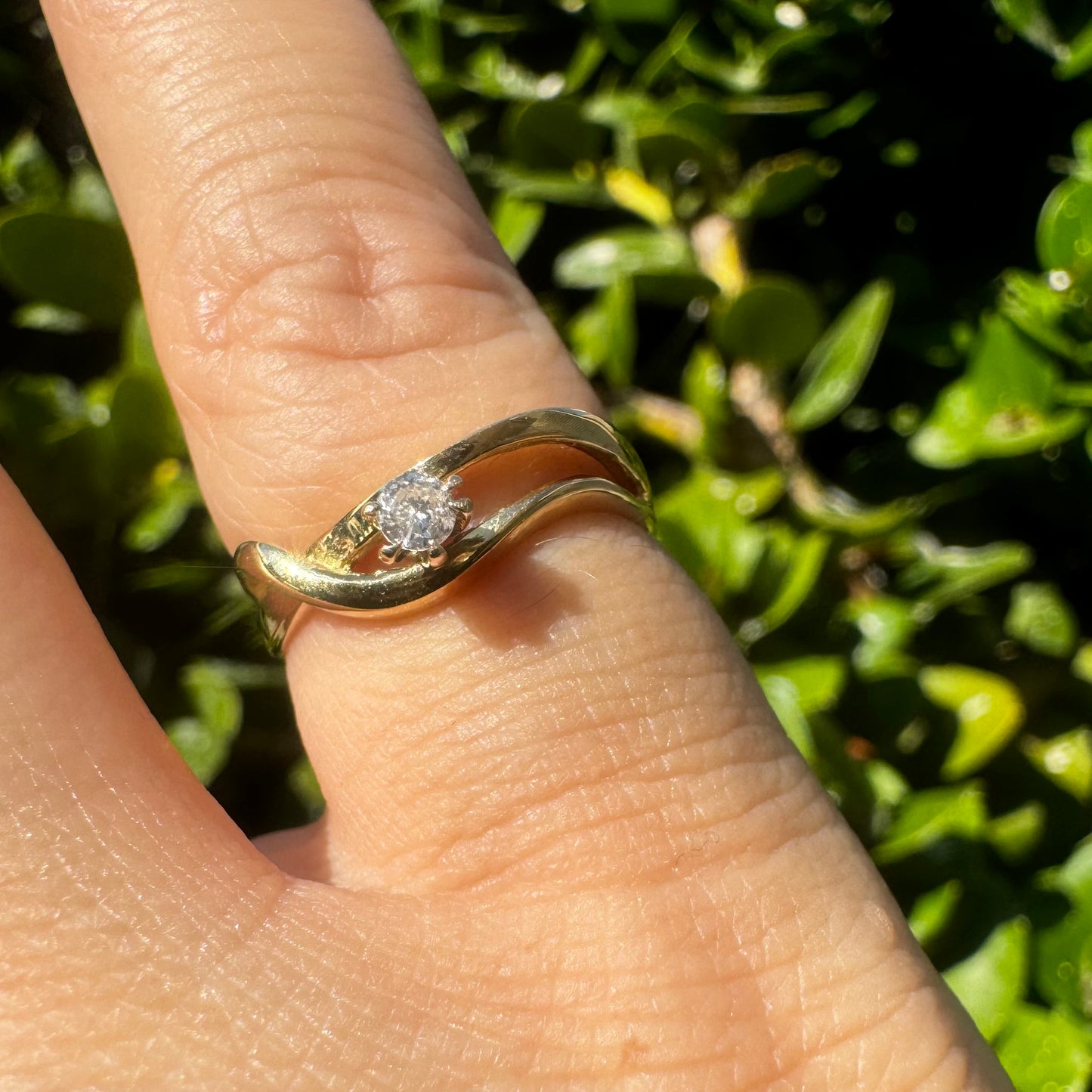 14K gold ring set with a single brilliant-cut diamond