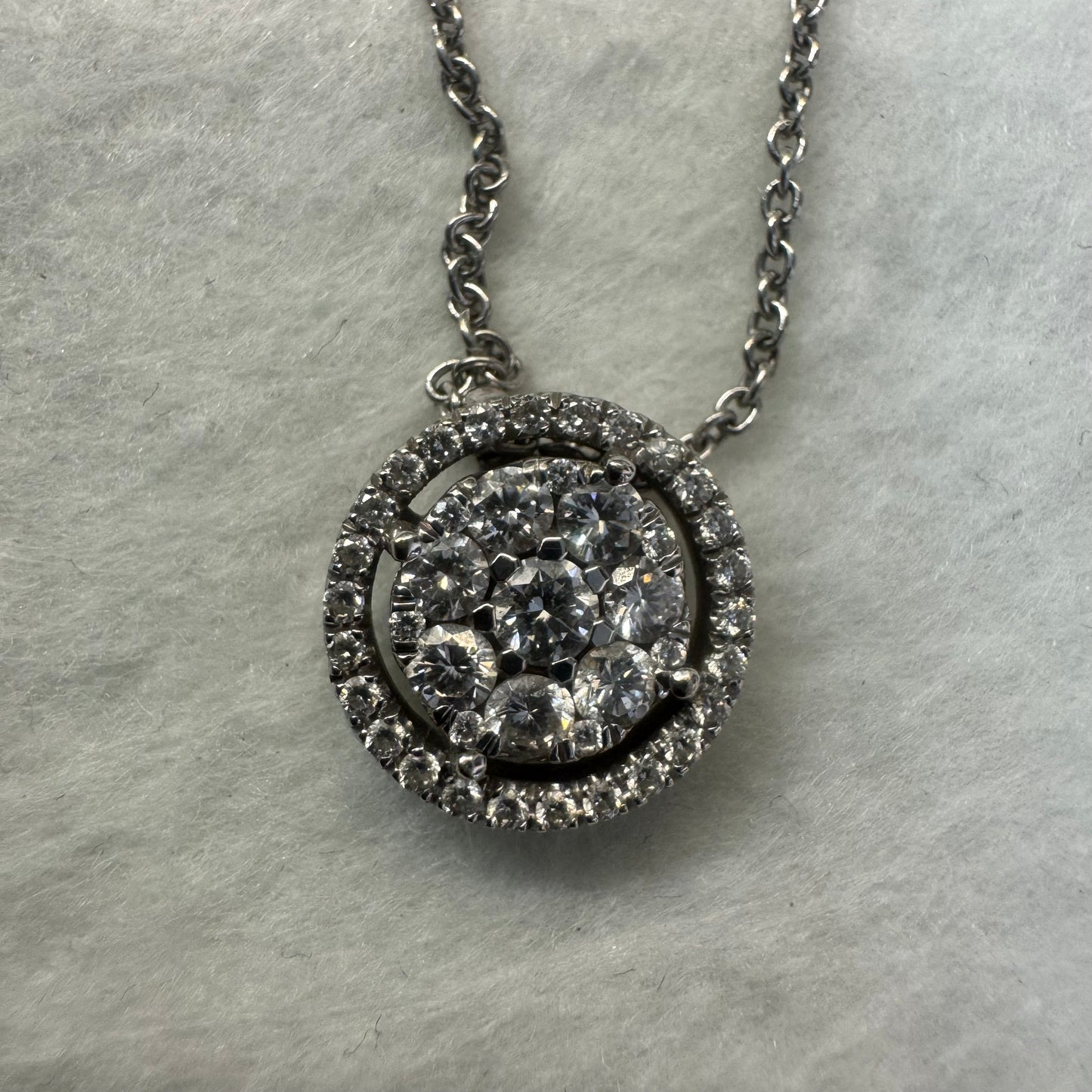 14K gold necklace featuring a round pendant set with a cluster of sparkling Diamonds