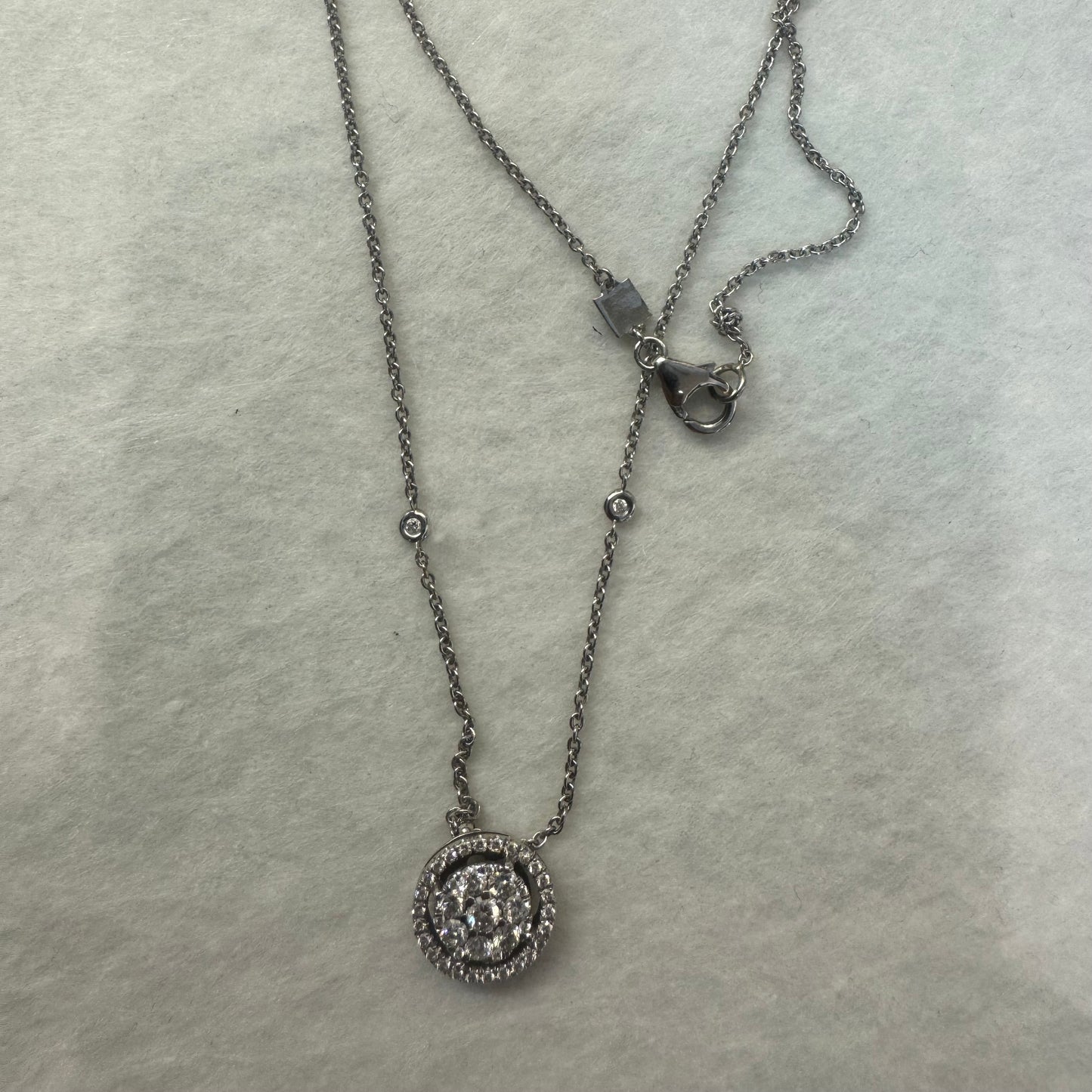 14K gold necklace featuring a round pendant set with a cluster of sparkling Diamonds