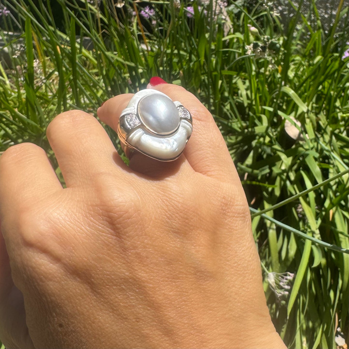 14K gold ring set with a natural mother-of-pearl centerpiece framed by delicate diamond accents