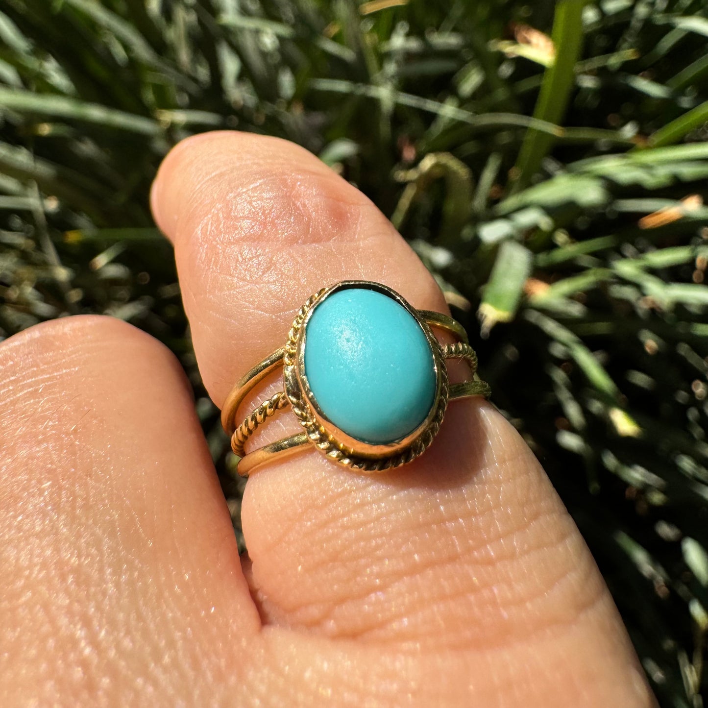 14K gold ring set with an oval Turquoise stone in a delicate rope-style bezel