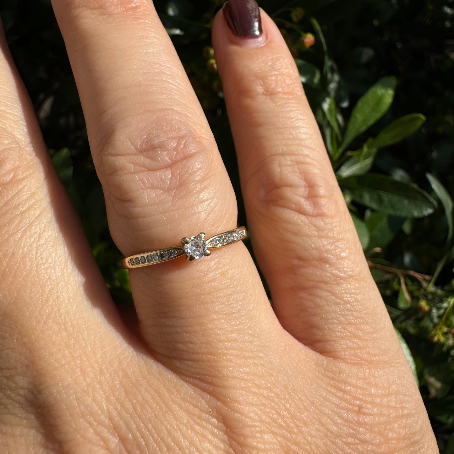 14K gold ring set with one center Diamond and side Diamonds