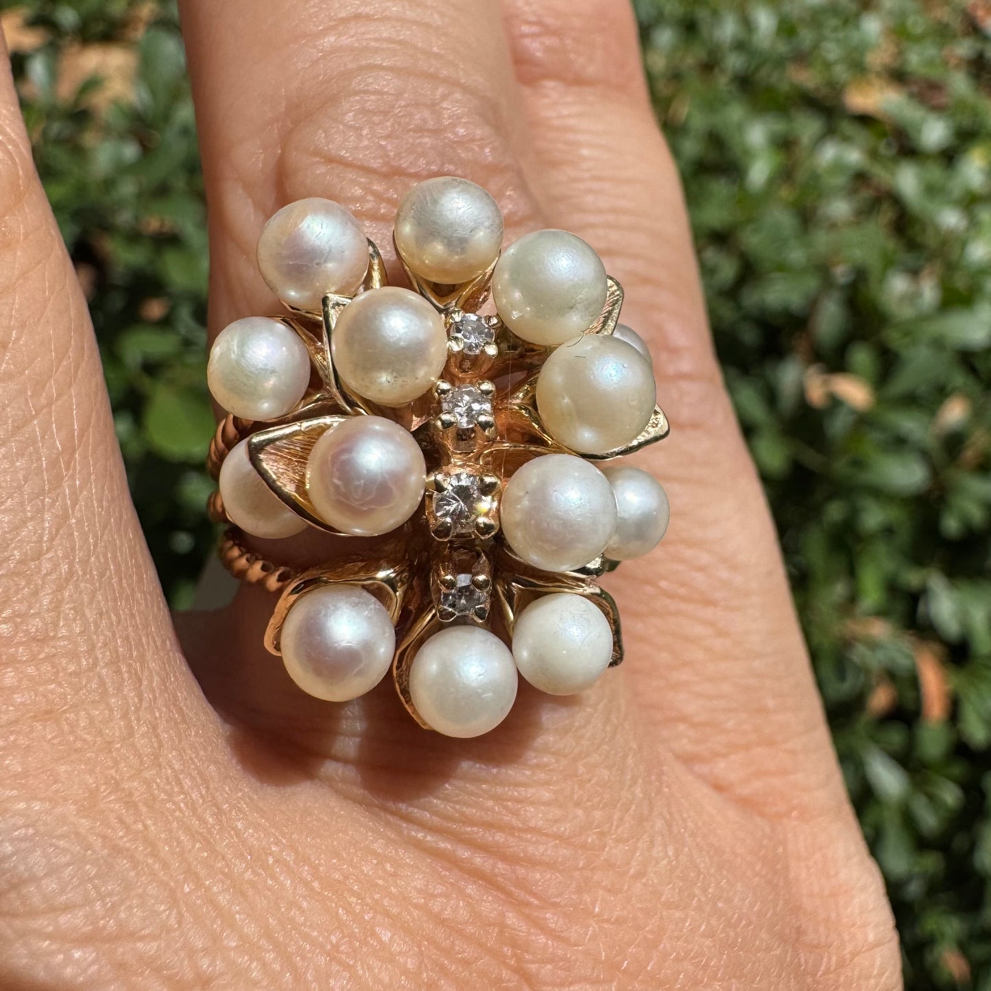 טבעת זהב צהוב 14 קראט משובצת בשפע של פנינים עגולות ולבנות, עם שורת יהלומים קטנים במרכז – יוצרת מראה פרחוני וזוהר שמושך את העין.