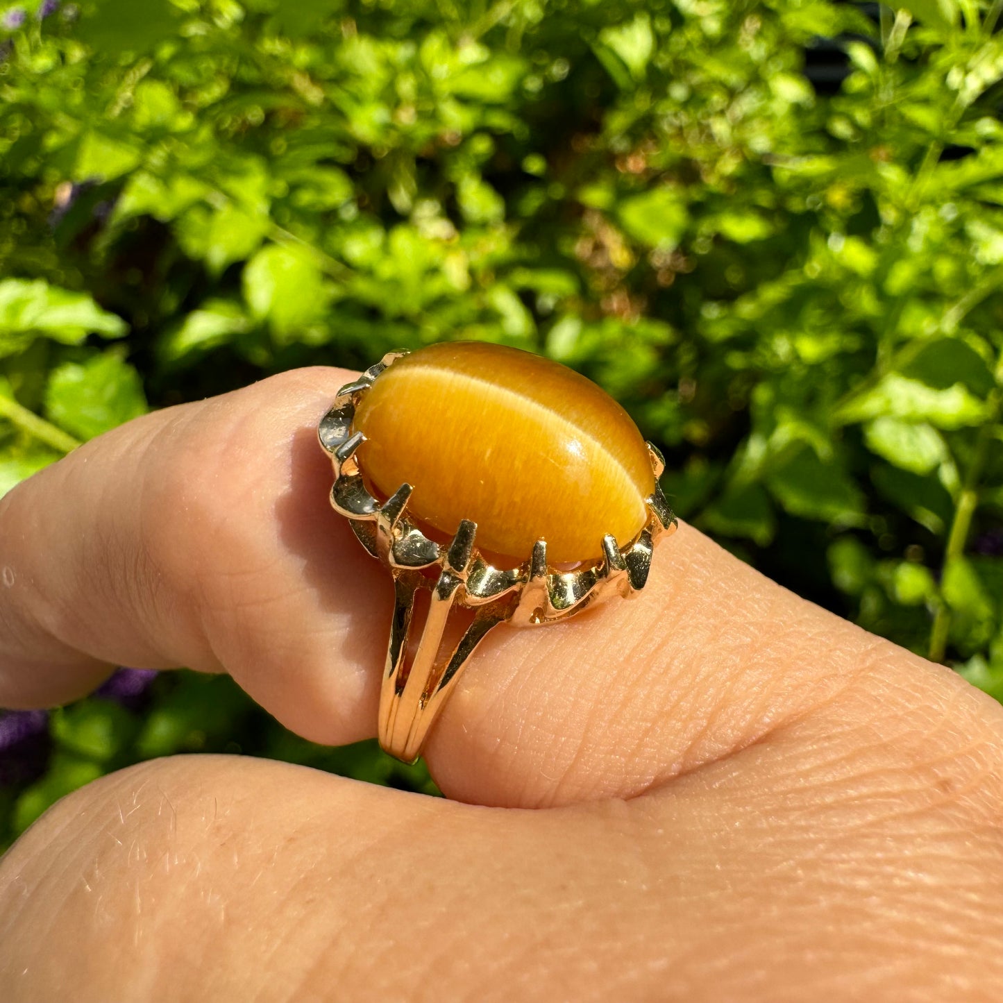 14K gold ring set with a yellow Tiger’s Eye cabochon