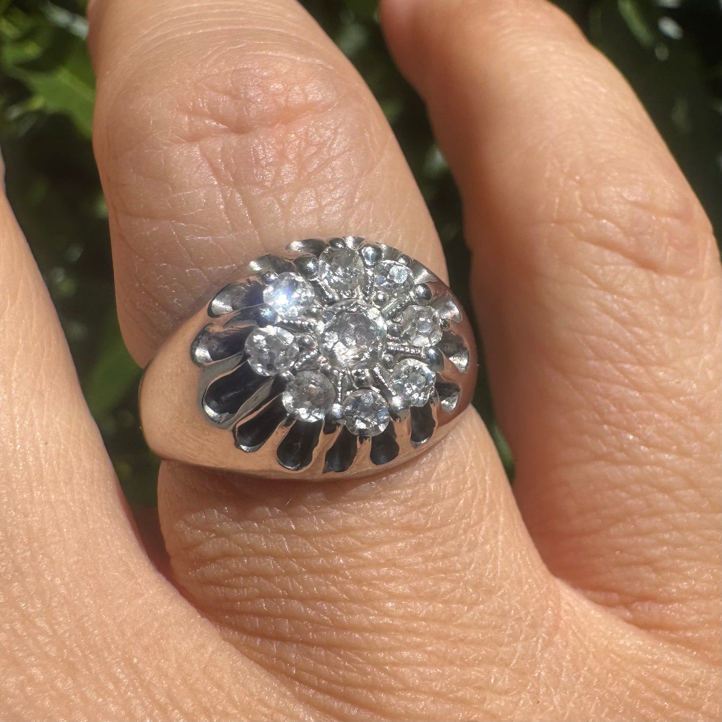 14K gold ring set with a cluster of old cut diamonds arranged in a floral design