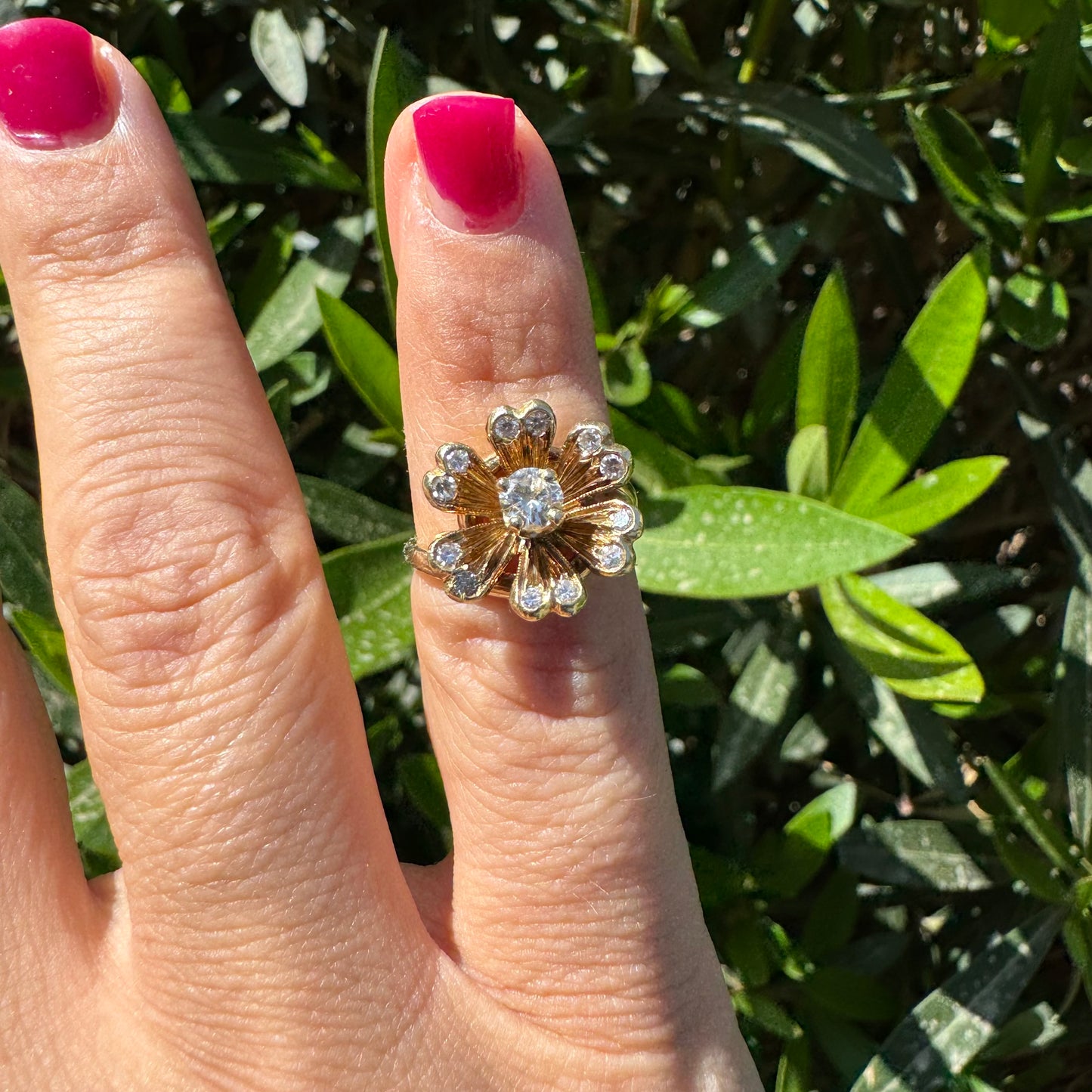 14K gold ring in a floral design, set with sparkling Diamonds at the center and around the petals.