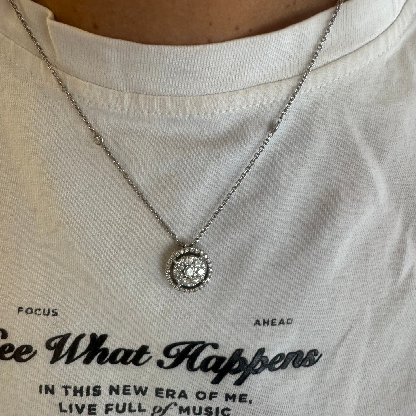 14K gold necklace featuring a round pendant set with a cluster of sparkling Diamonds