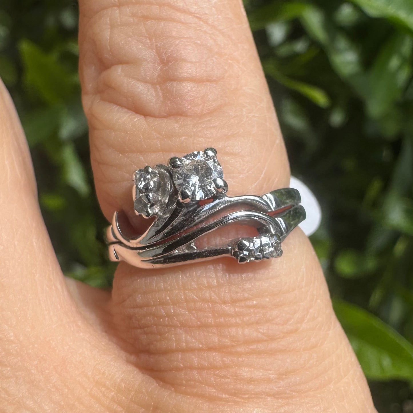 14K gold ring set with round-cut diamonds in a flowing design