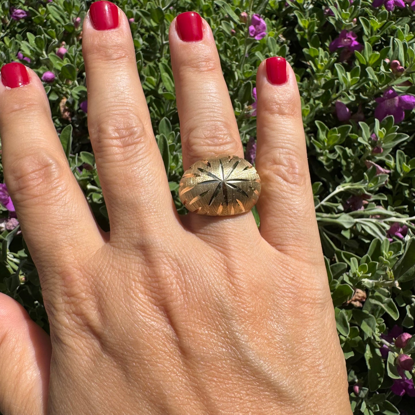 14K gold dome ring crafted in textured gold, featuring intricate engraved starburst detailing