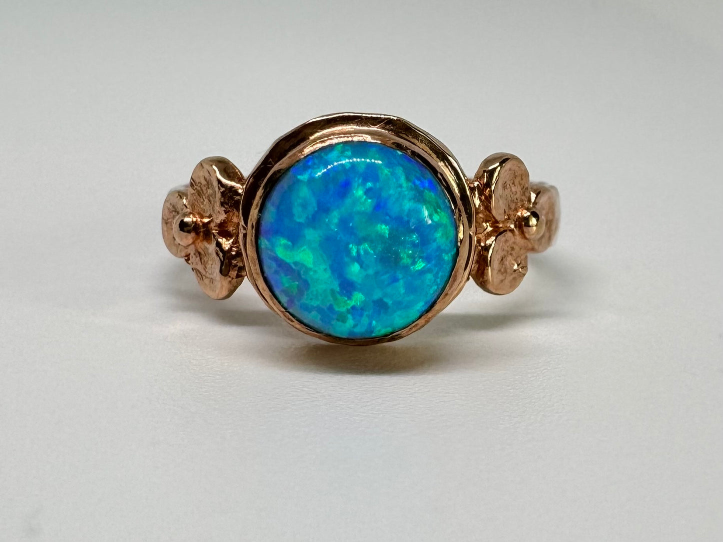 10K gold ring set with round Opal with vibrant flashes of blue, green and white