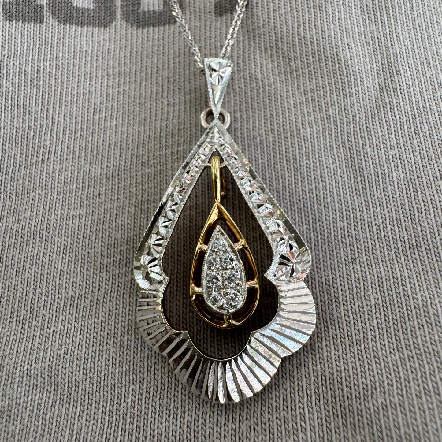 14K white and yellow gold pendant in a unique geometric design set with Diamonds